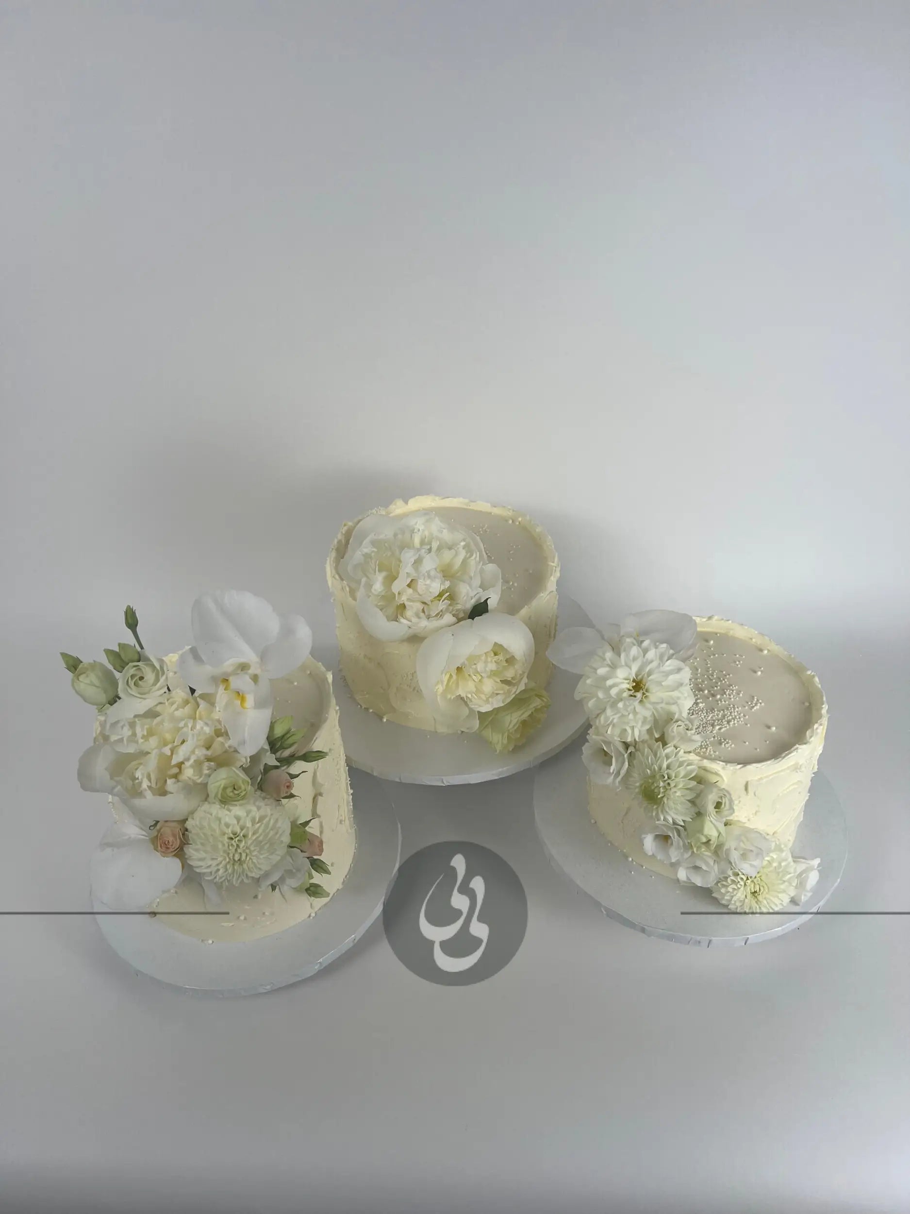 Cascading fresh blooms on buttercream - wedding cake