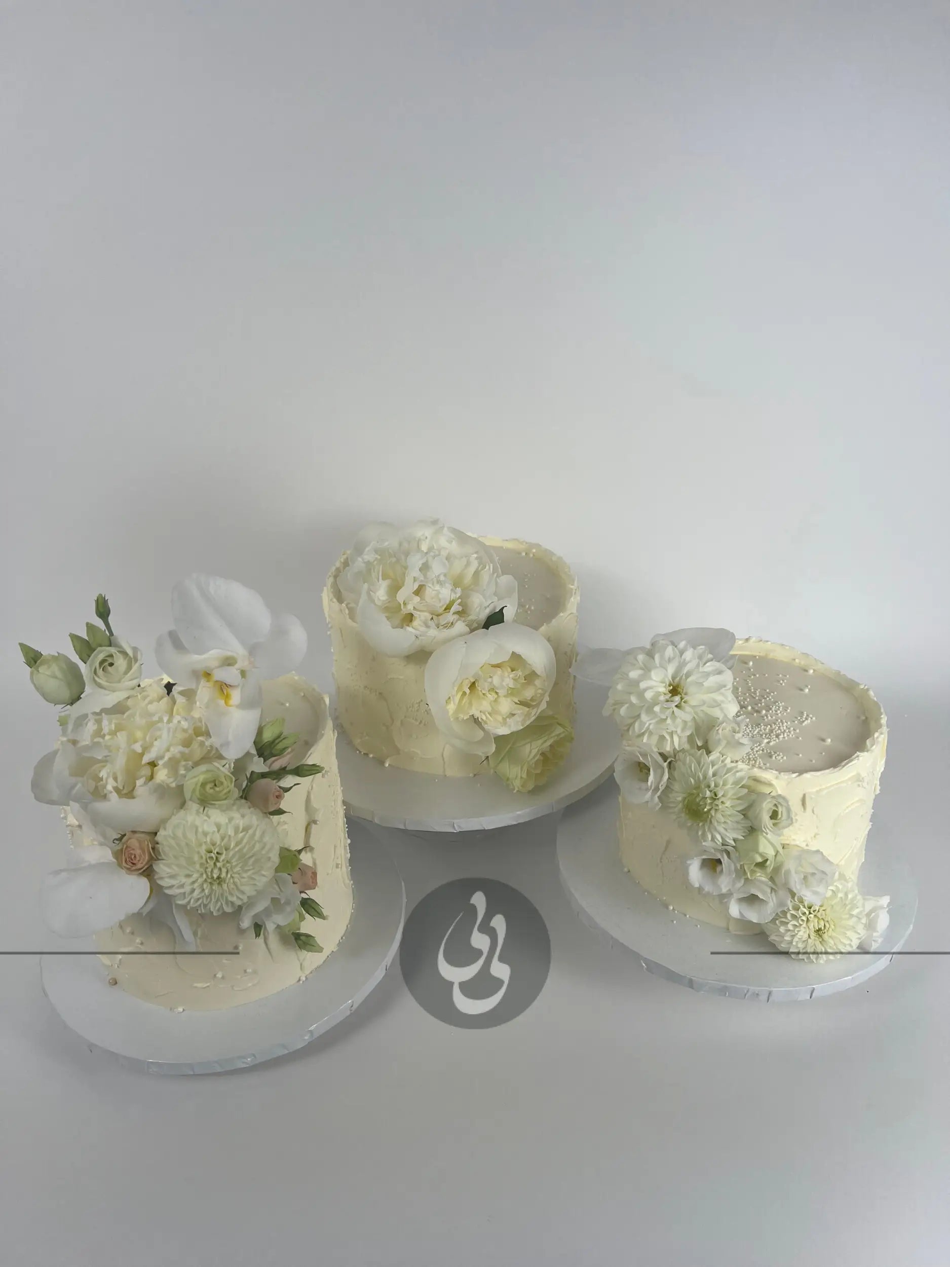 Cascading fresh blooms on buttercream - wedding cake