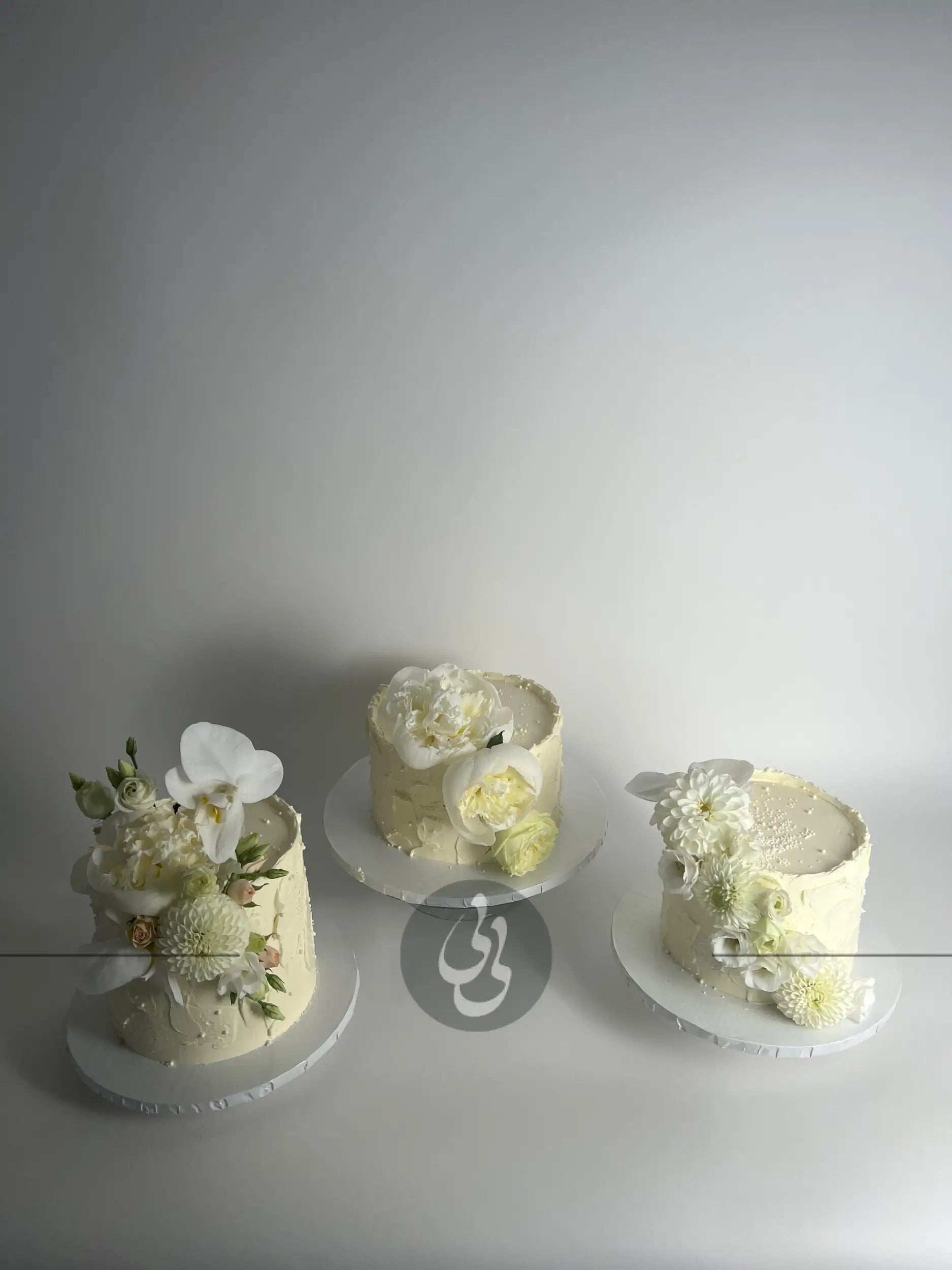 Cascading fresh blooms on buttercream - wedding cake