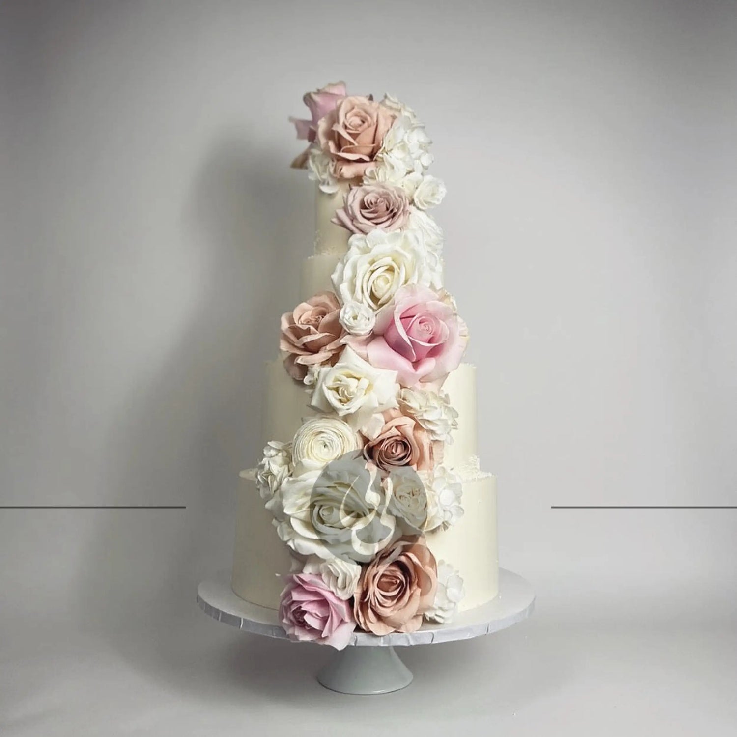 Cascading fresh flowers on buttercream - wedding cake