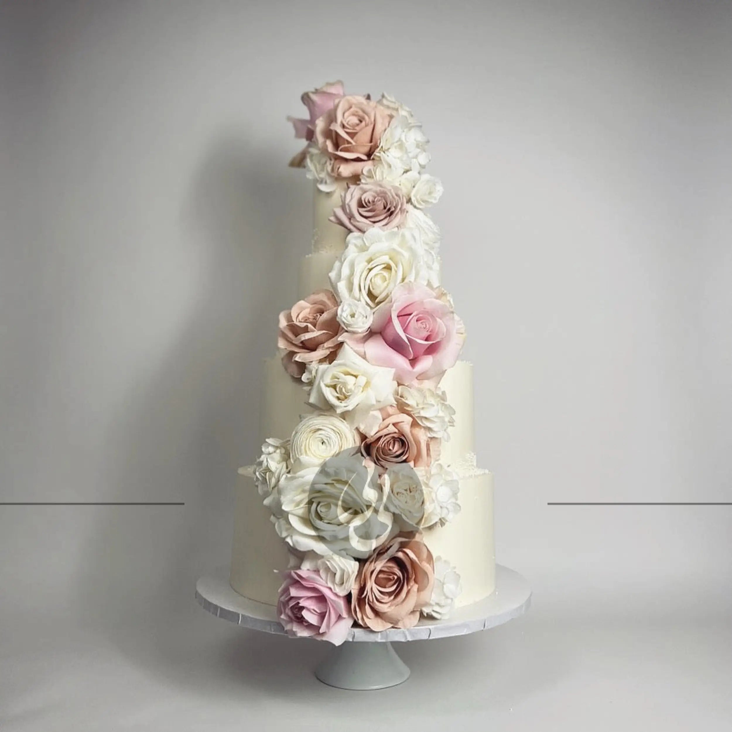 Cascading fresh flowers on buttercream - wedding cake