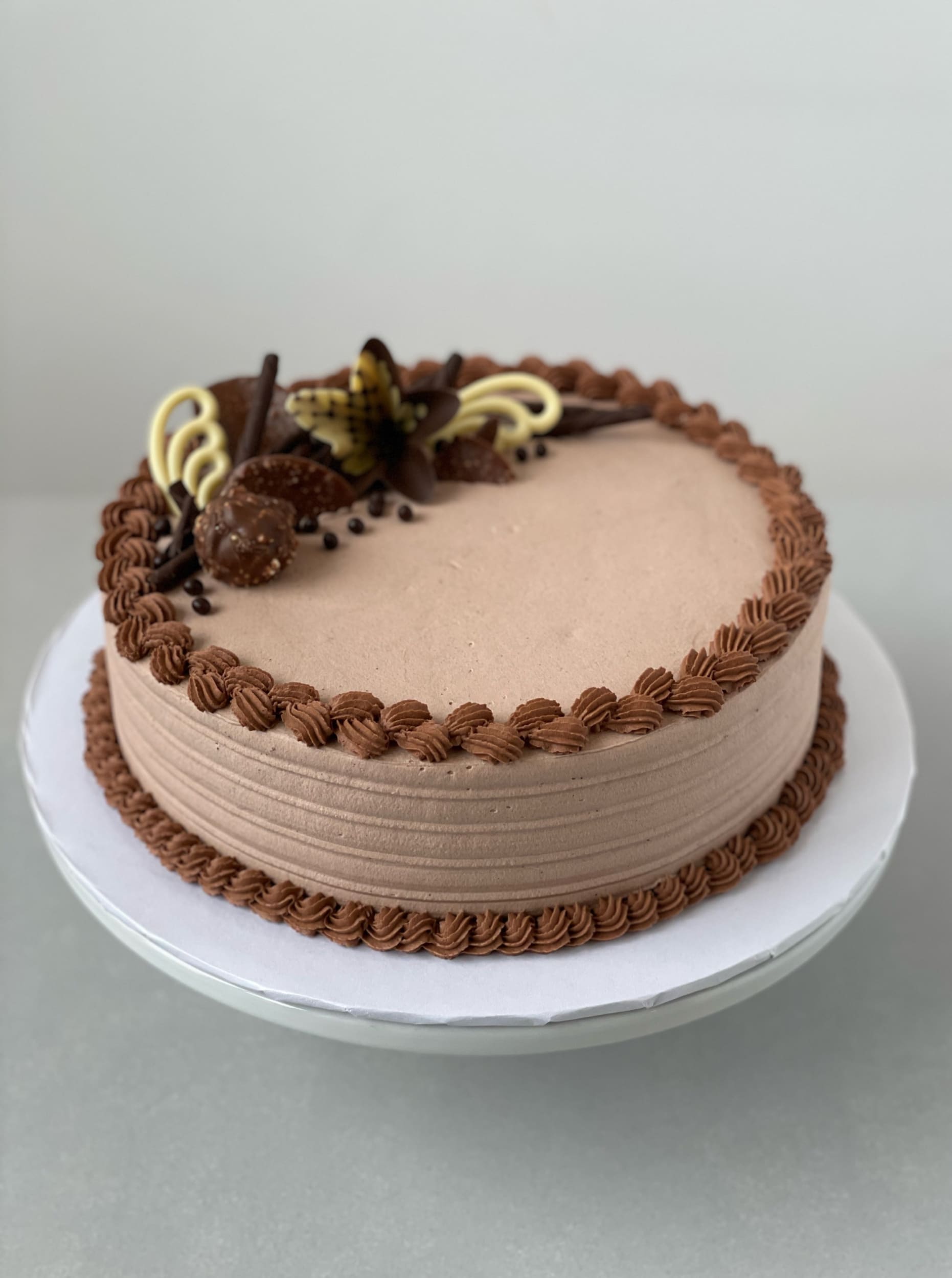 Chocolate decorations on whipped cream - custom cake