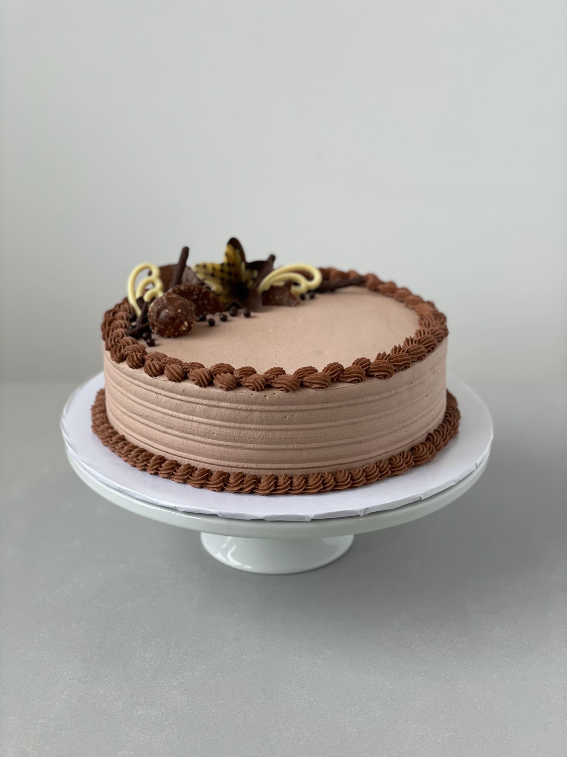 Chocolate decorations on whipped cream - custom cake