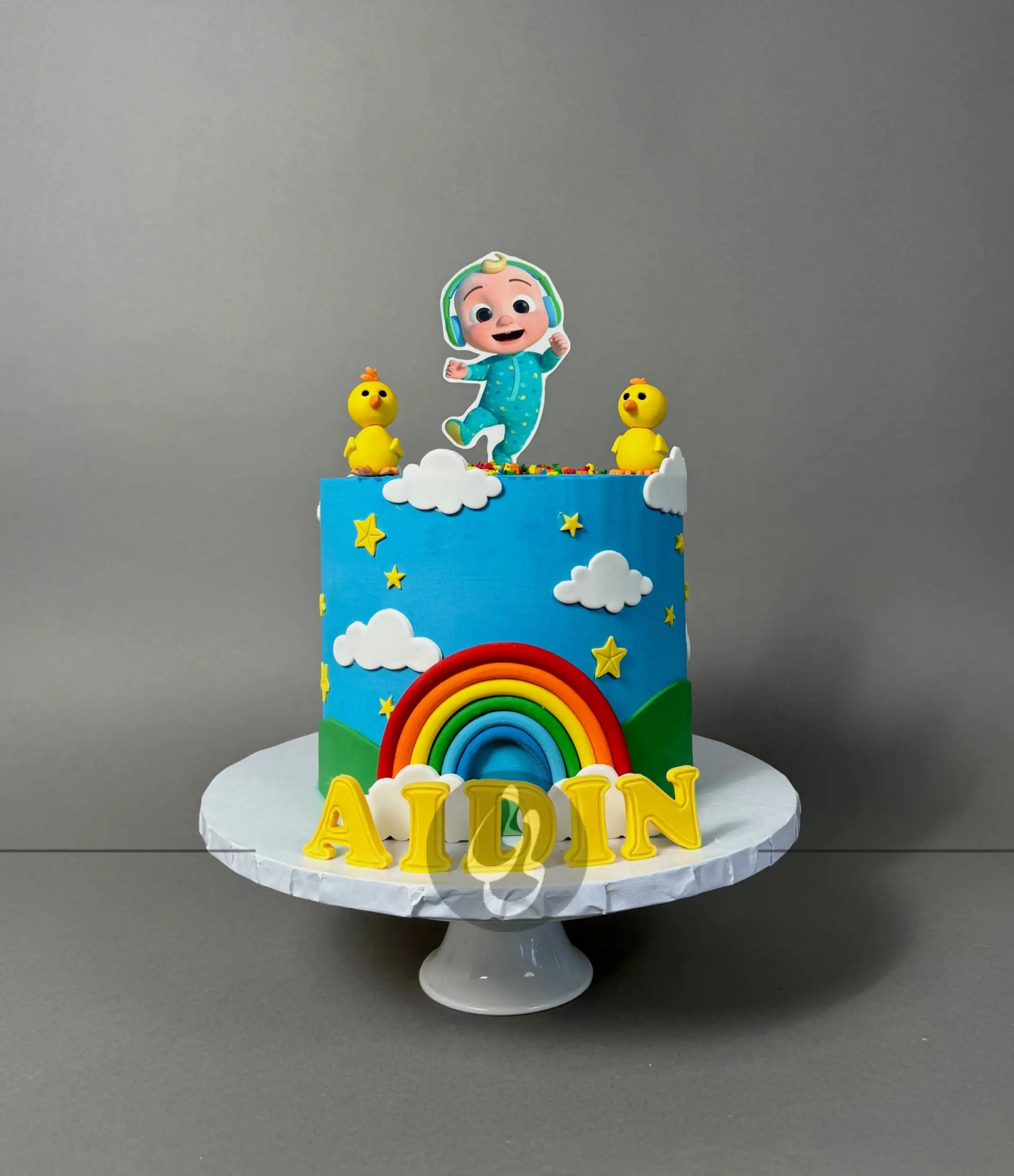 Cocomelon jj & rainbow in edible print - custom cake