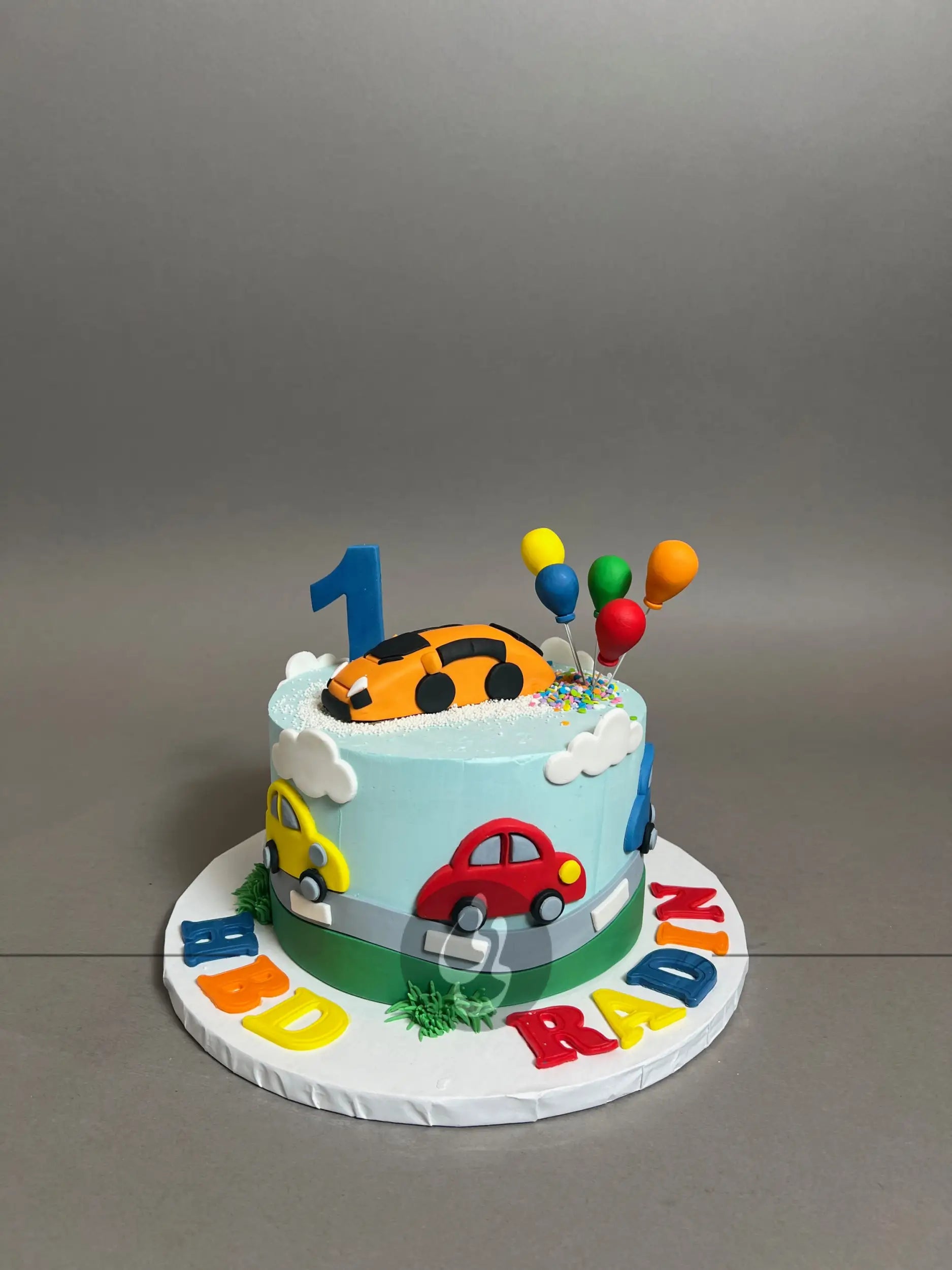 Colourful cars on buttercream - custom cake