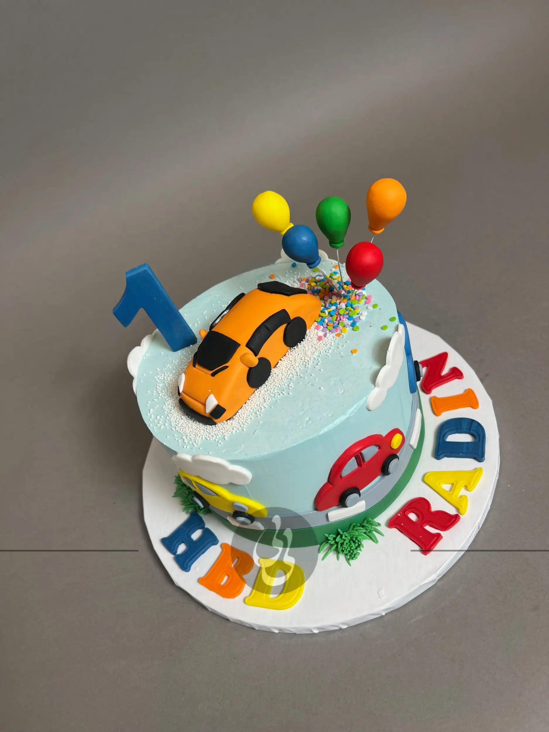 Colourful cars on buttercream - custom cake
