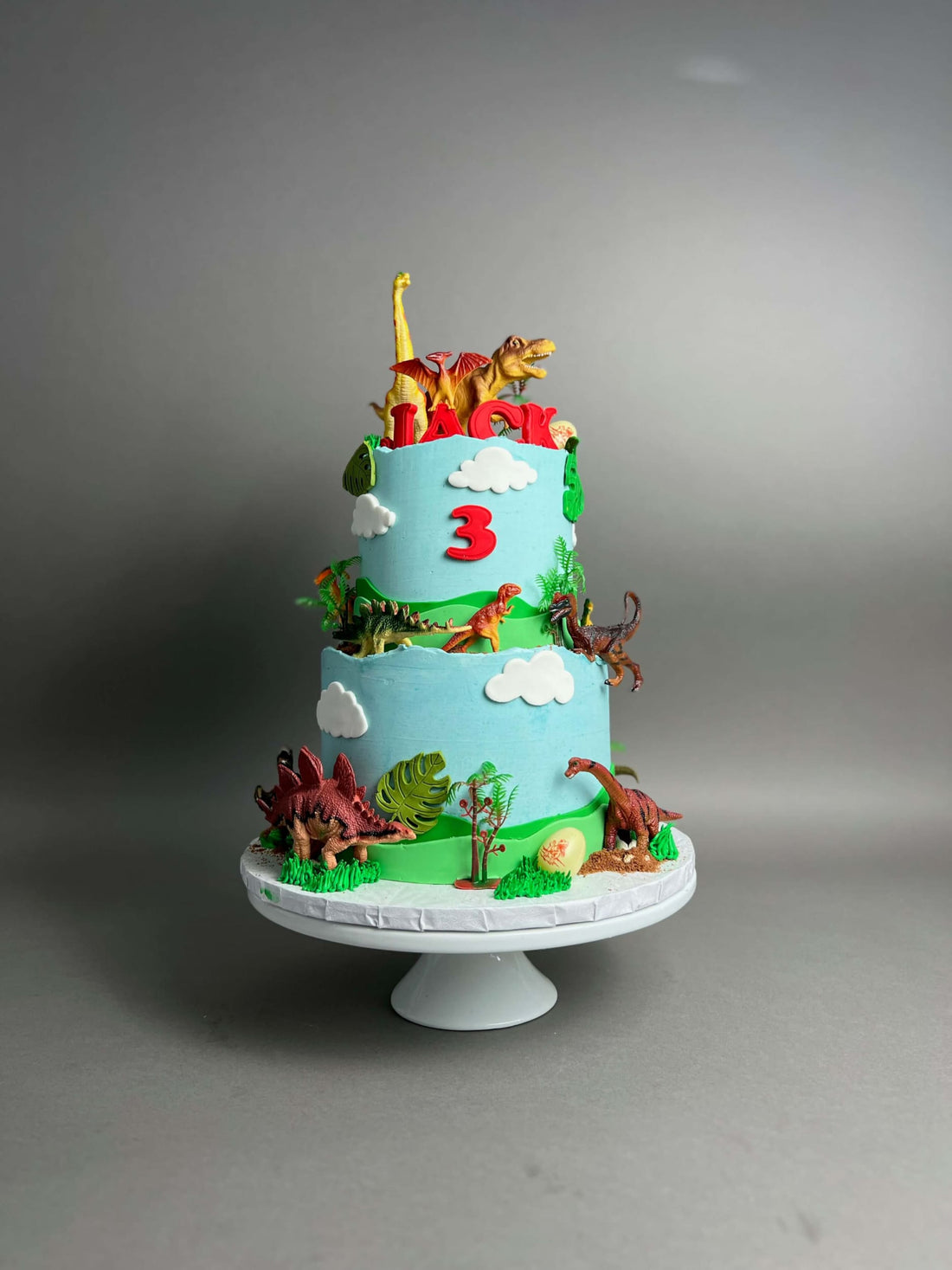 Dinosaur toys on buttercream - custom cake