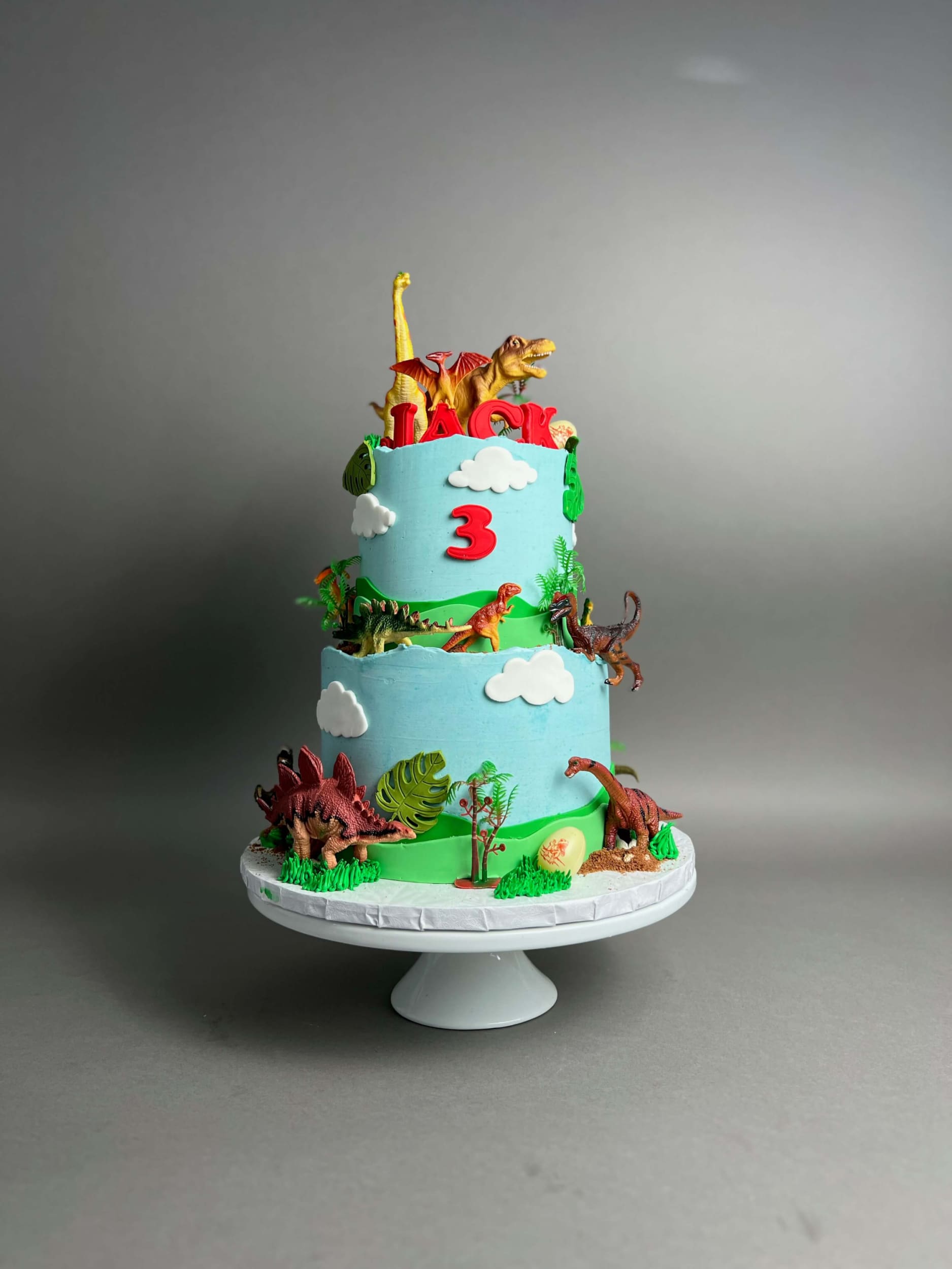 Dinosaur toys on buttercream - custom cake