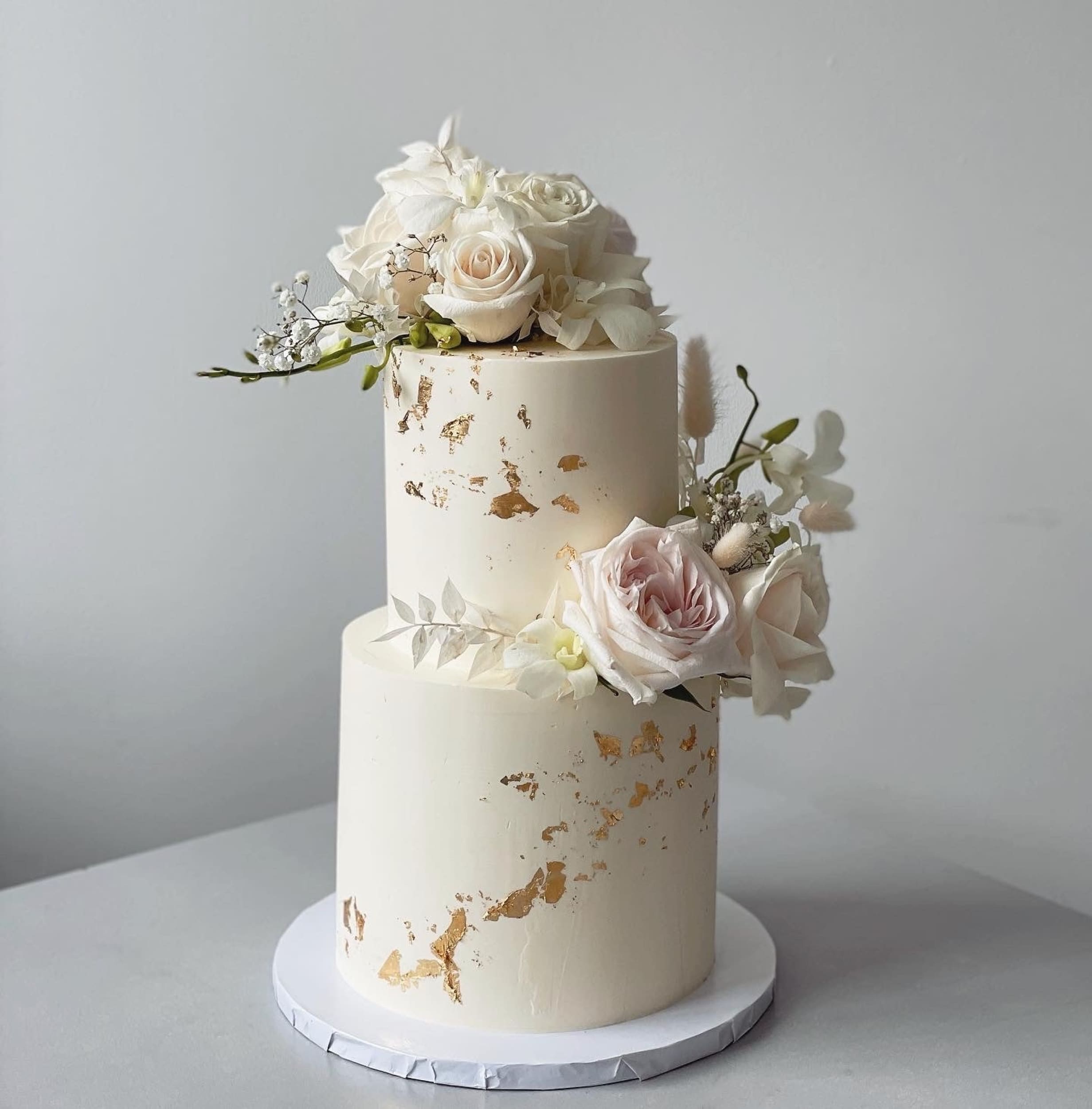 Fresh blooms on buttercream - wedding cake