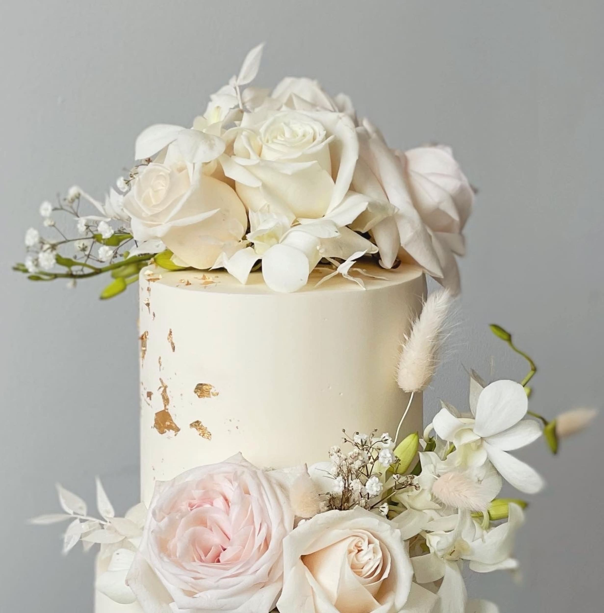 Fresh blooms on buttercream - wedding cake