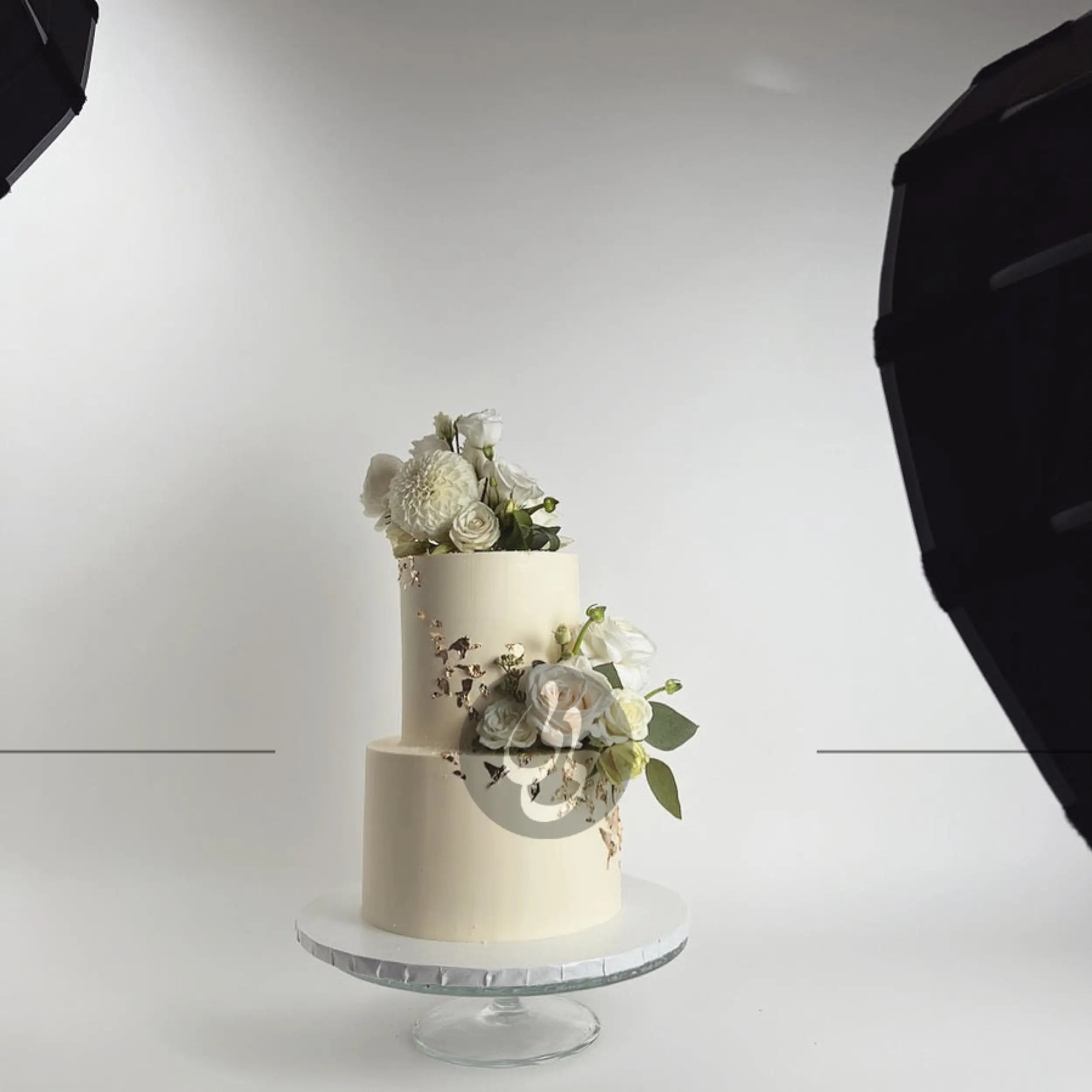 Fresh flowers on gilded buttercream - wedding cake