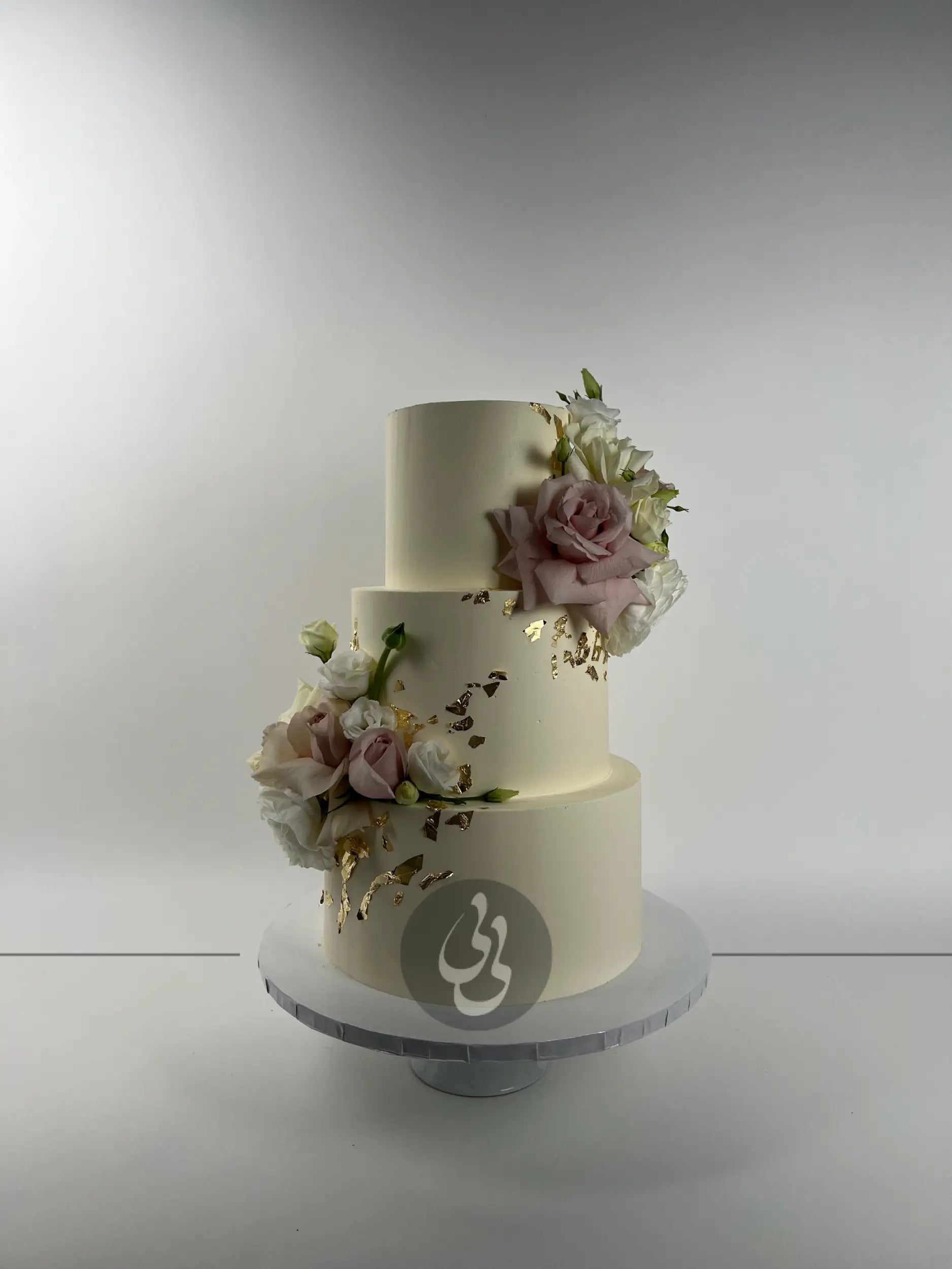 Fresh flowers on gilded buttercream - wedding cake