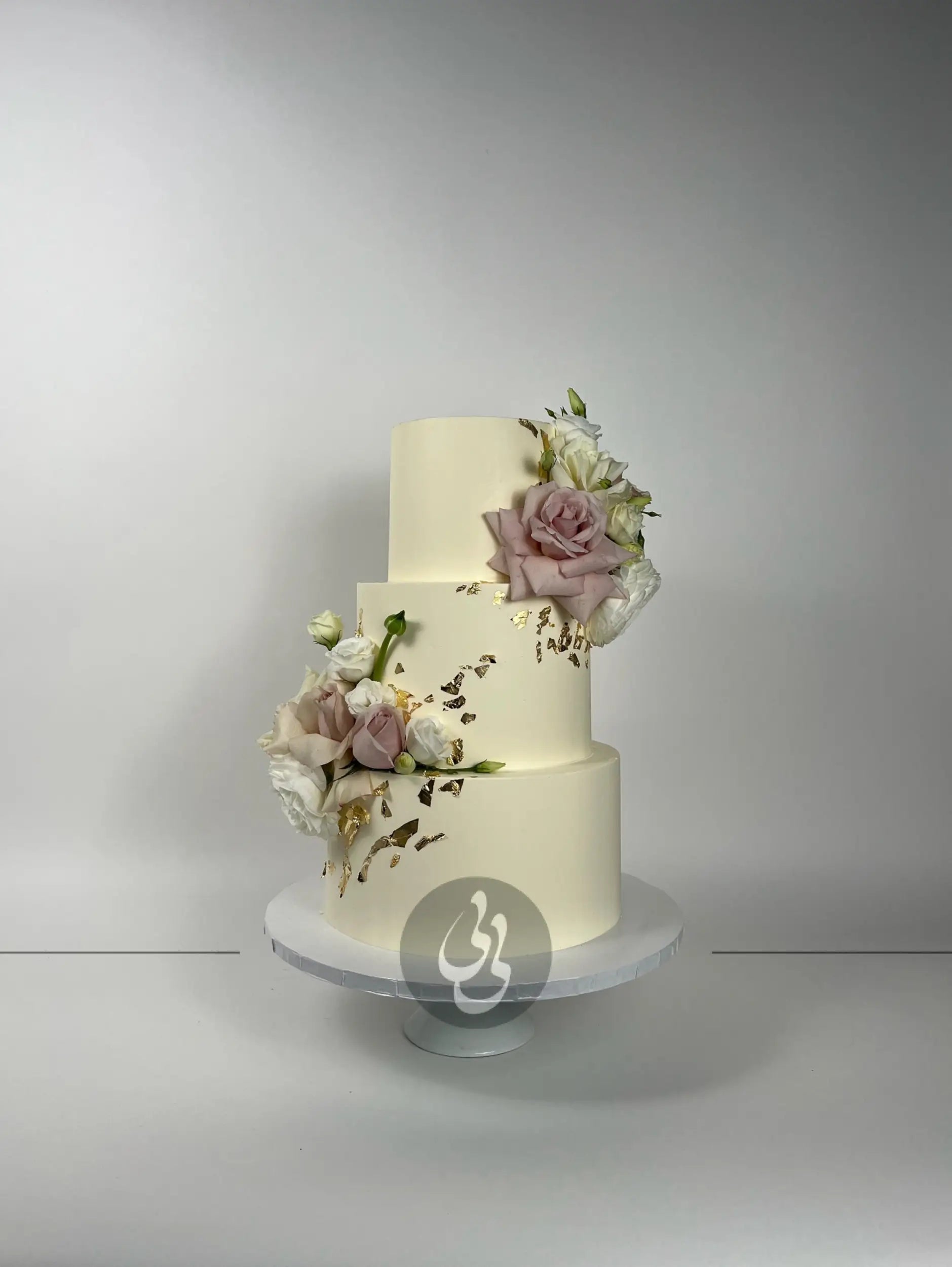 Fresh flowers on gilded buttercream - wedding cake