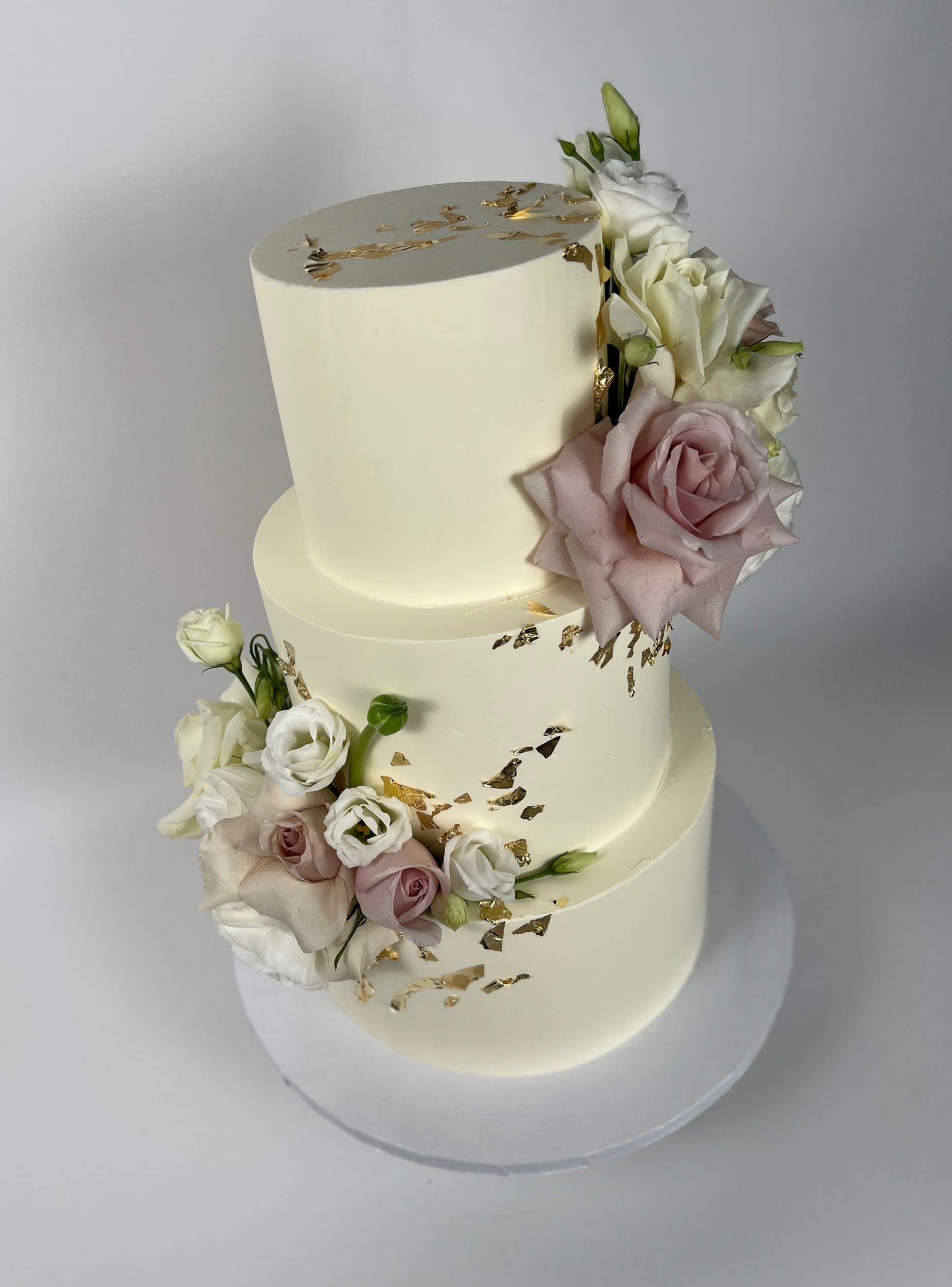 Fresh flowers on gilded buttercream - wedding cake