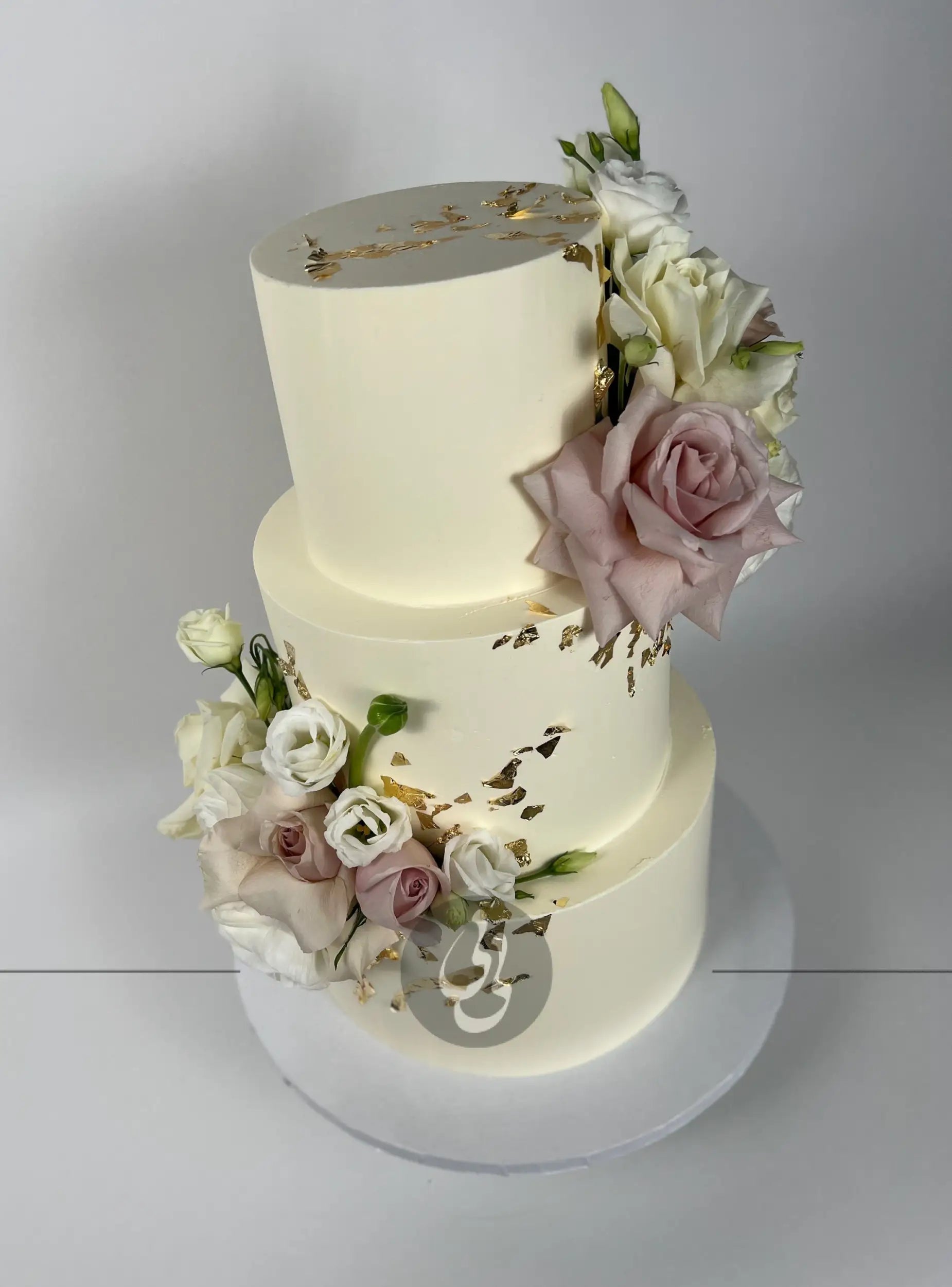 Fresh flowers on gilded buttercream - wedding cake