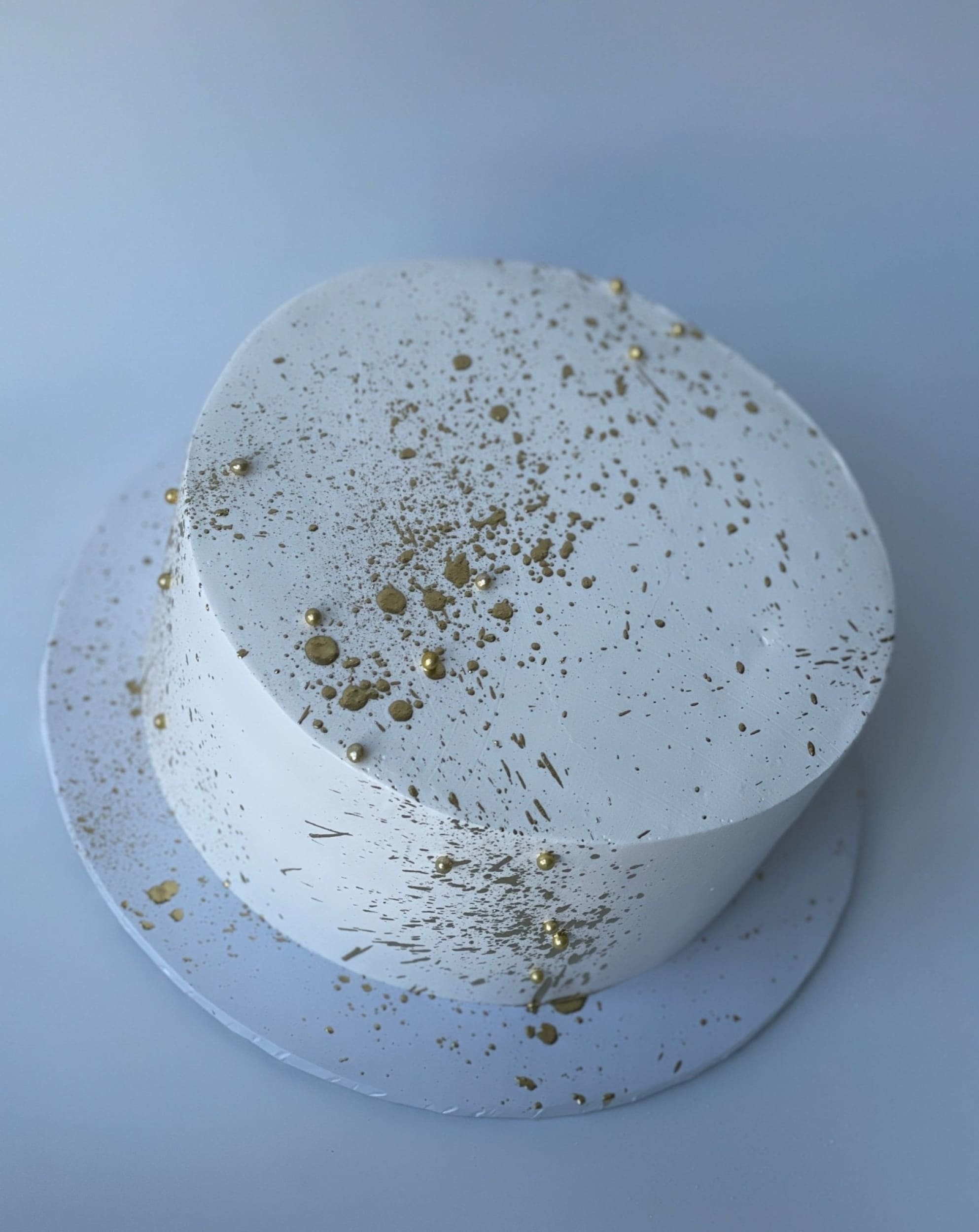 Gold splatter on whipped cream - custom cake