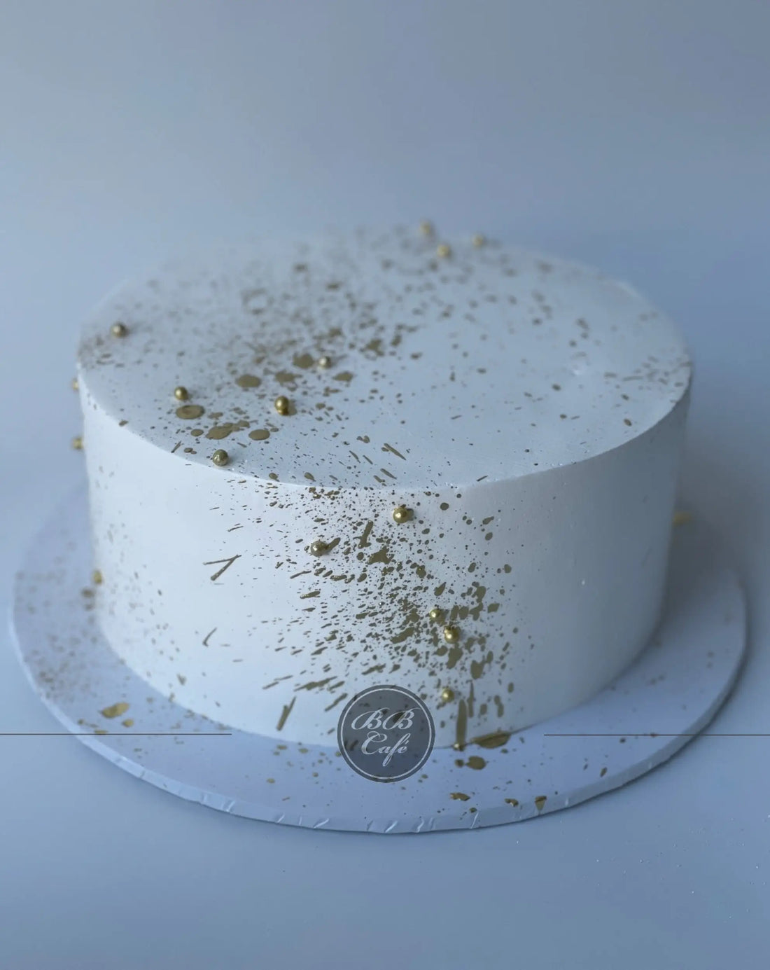 Gold splatter on whipped cream - custom cake