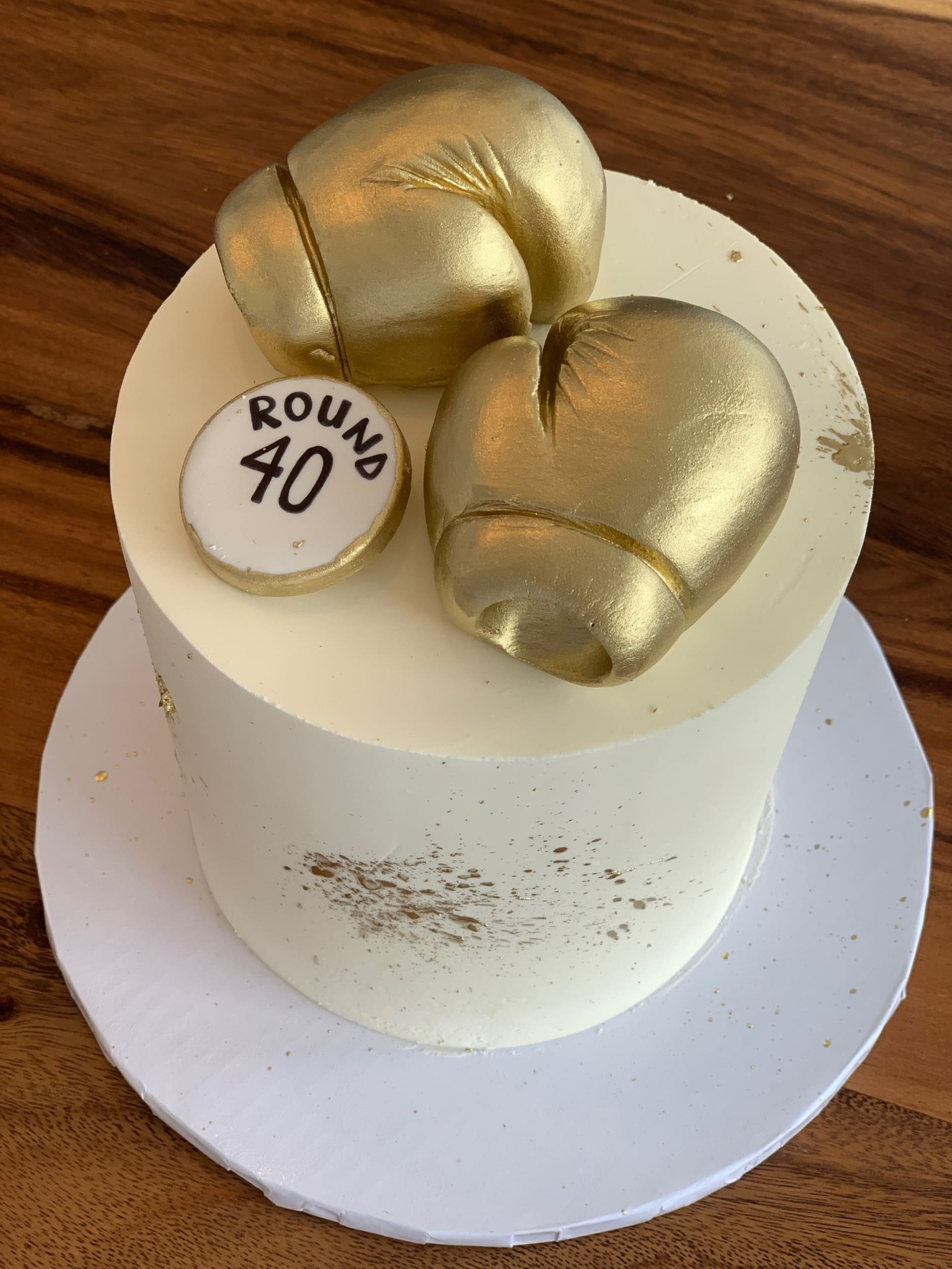 Golden boxing gloves on buttercream - custom cake
