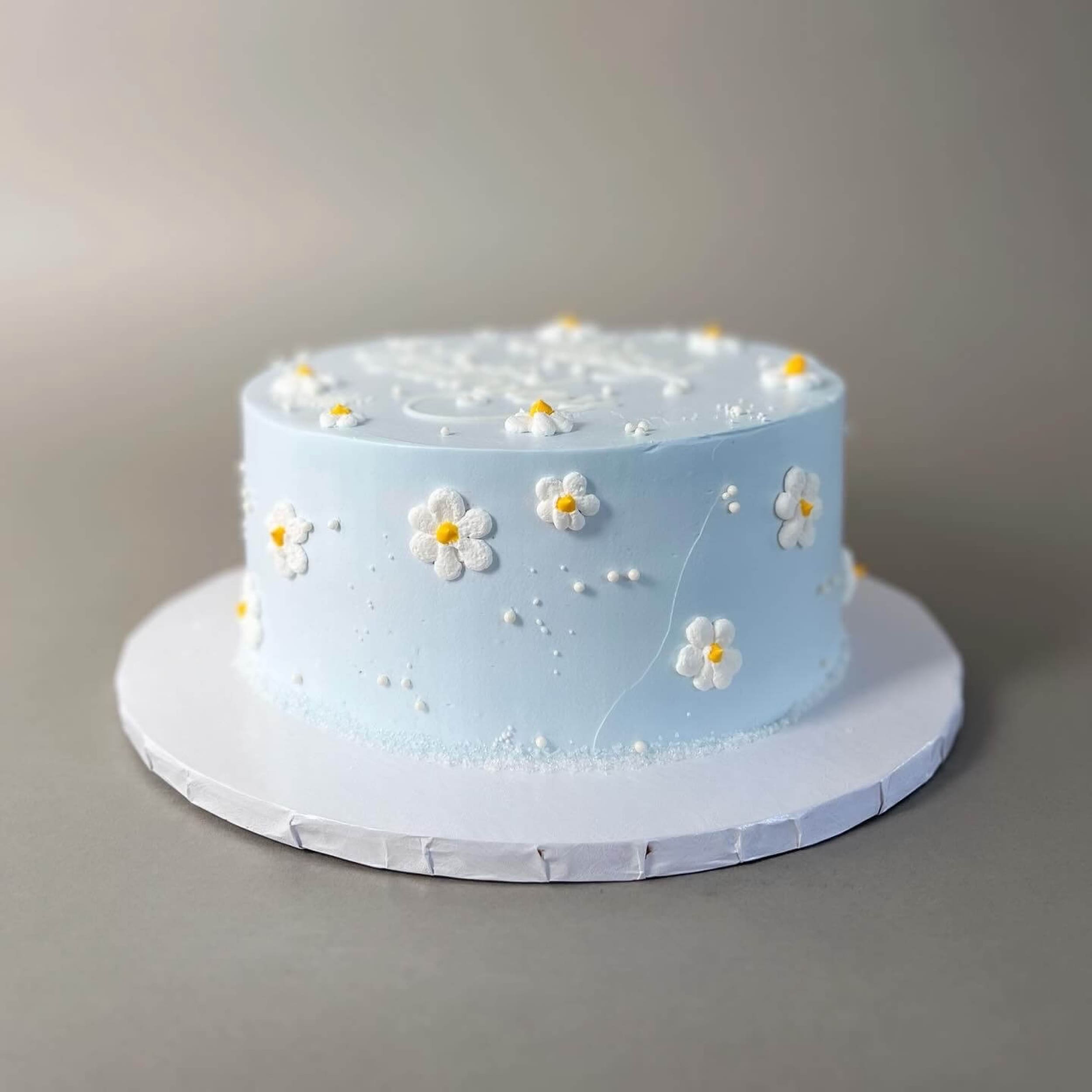Hand piped daisies on whipped cream - custom cake