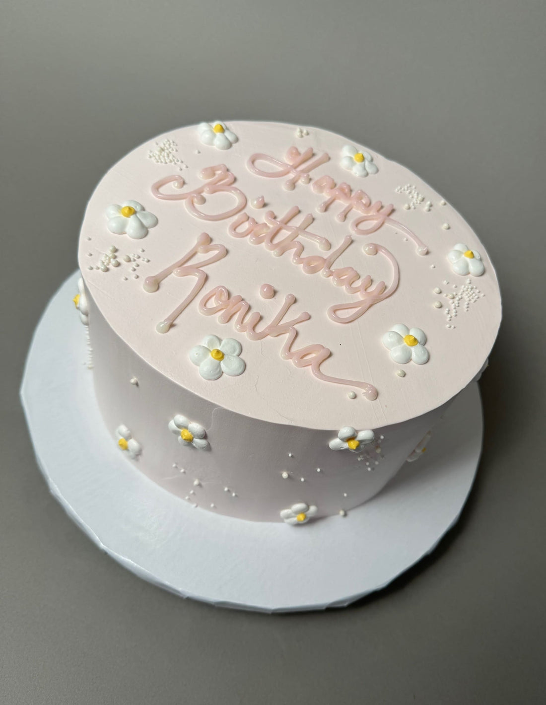 Hand piped daisies on whipped cream - custom cake