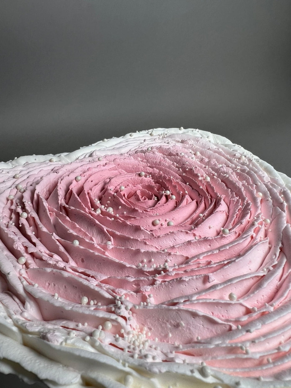 Hand piped ruffled rose on whipped cream heart - custom cake