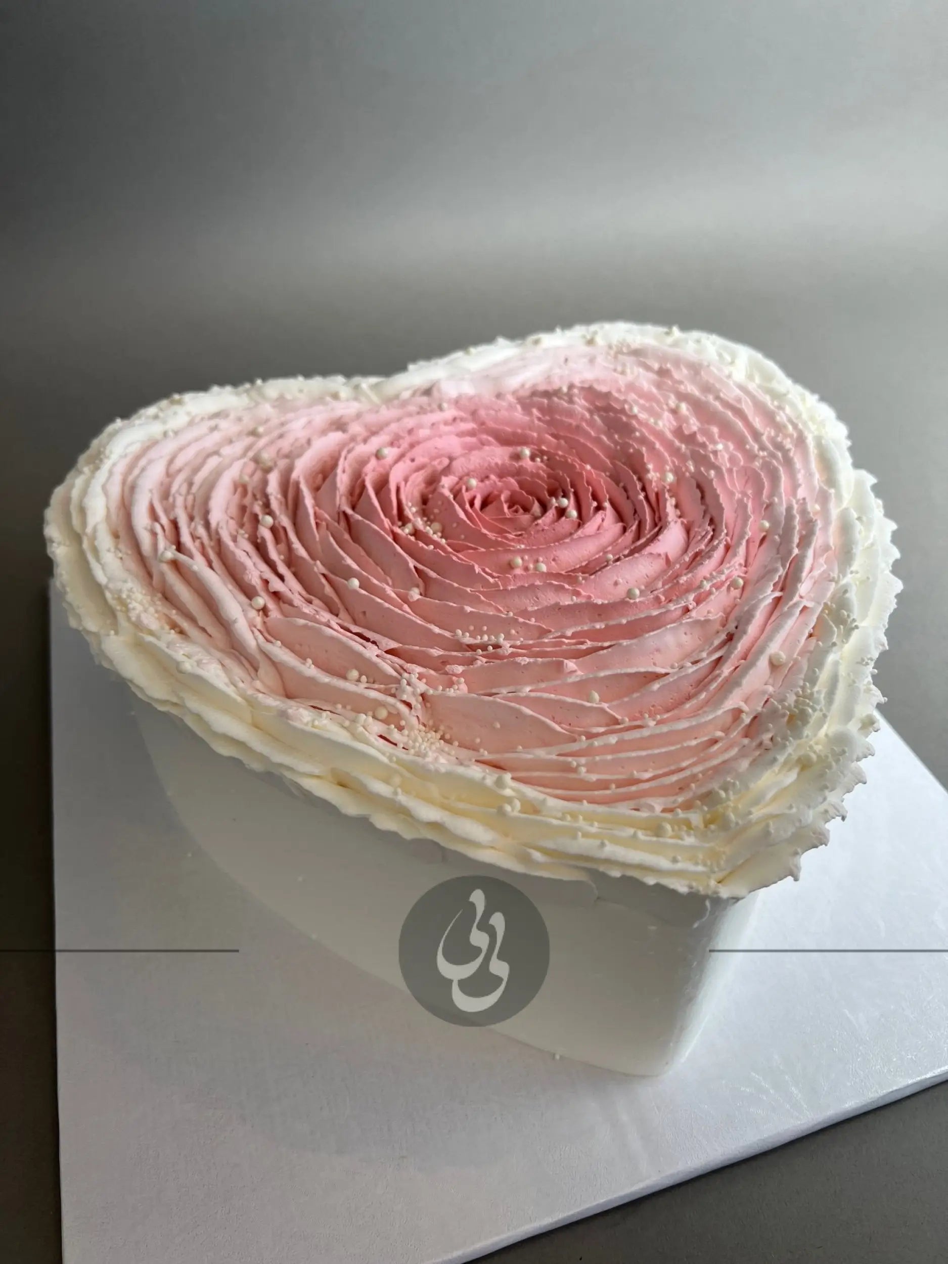 Hand piped ruffled rose on whipped cream heart - custom cake