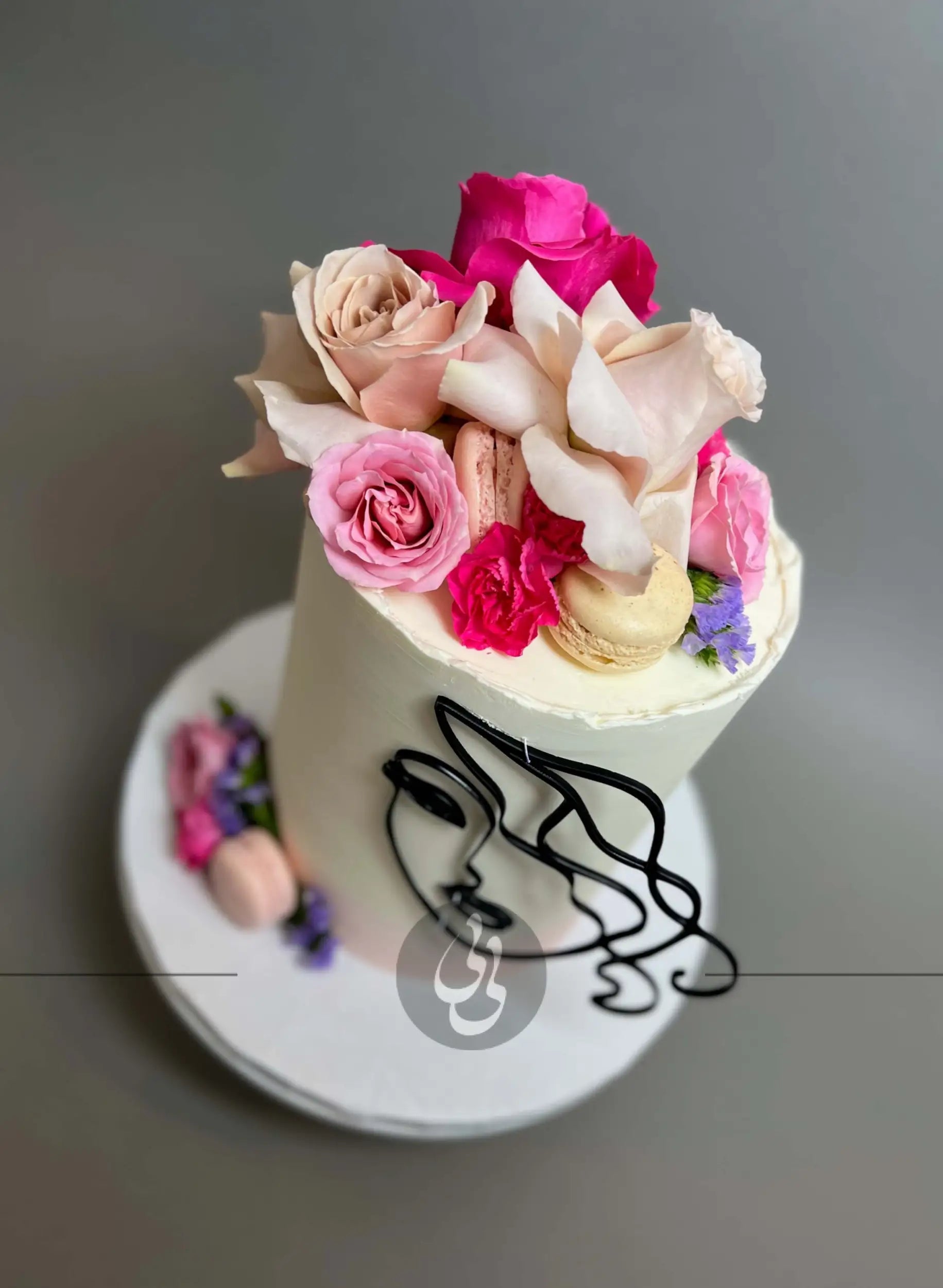 Laser-cut face & floral buttercream cake - custom cake