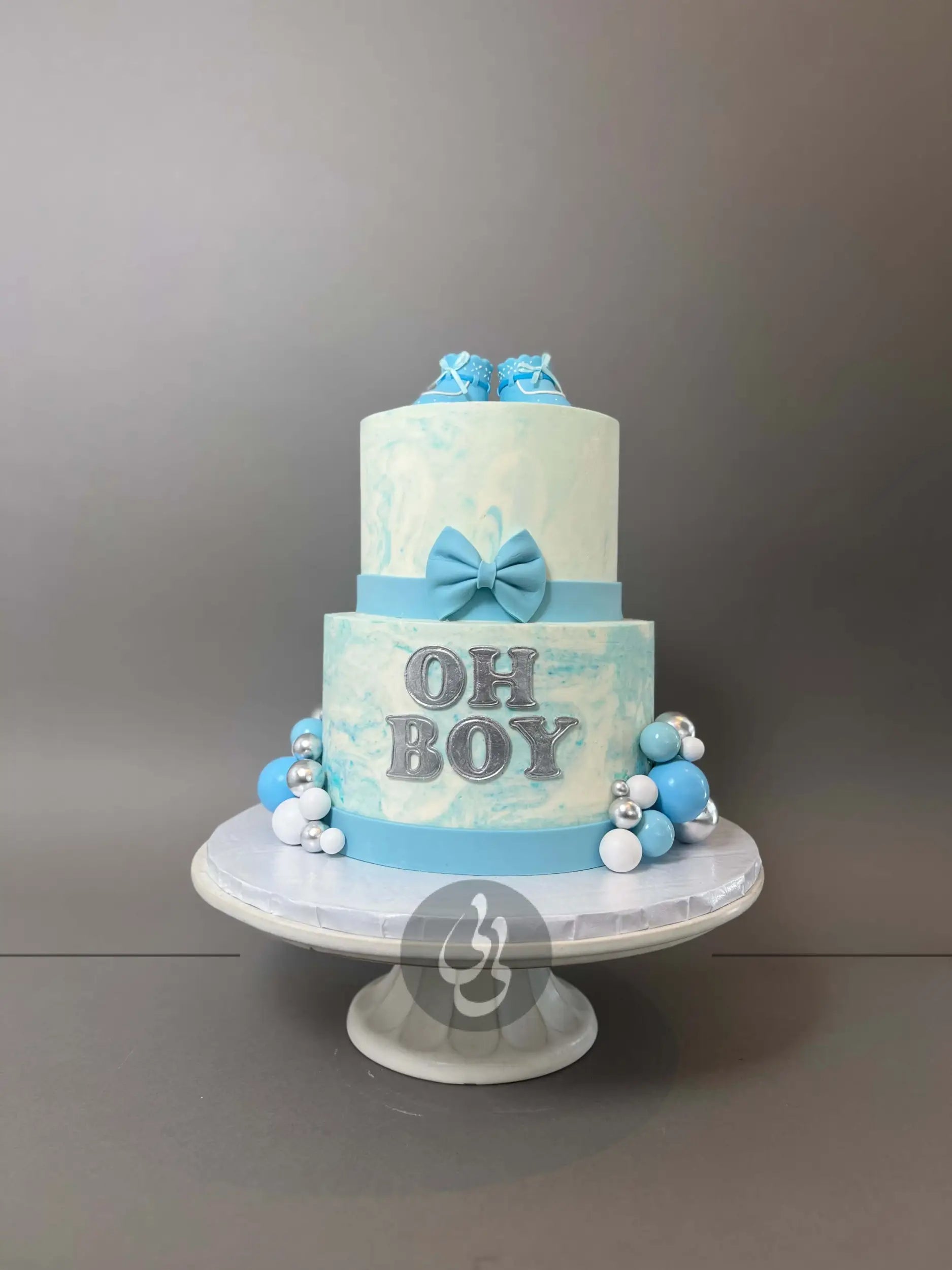 Oh baby booties on marble buttercream - custom cake