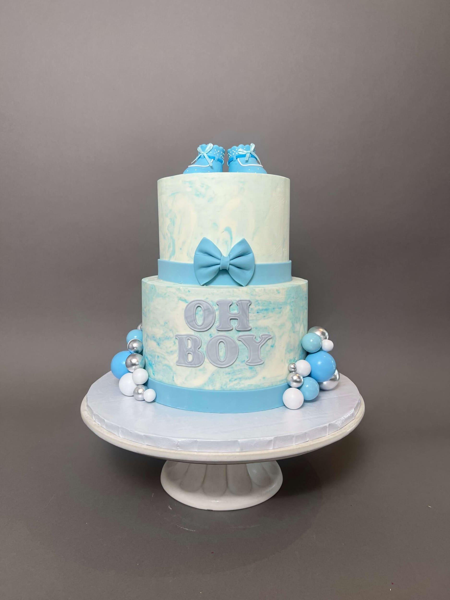 Oh baby booties on marble buttercream - custom cake