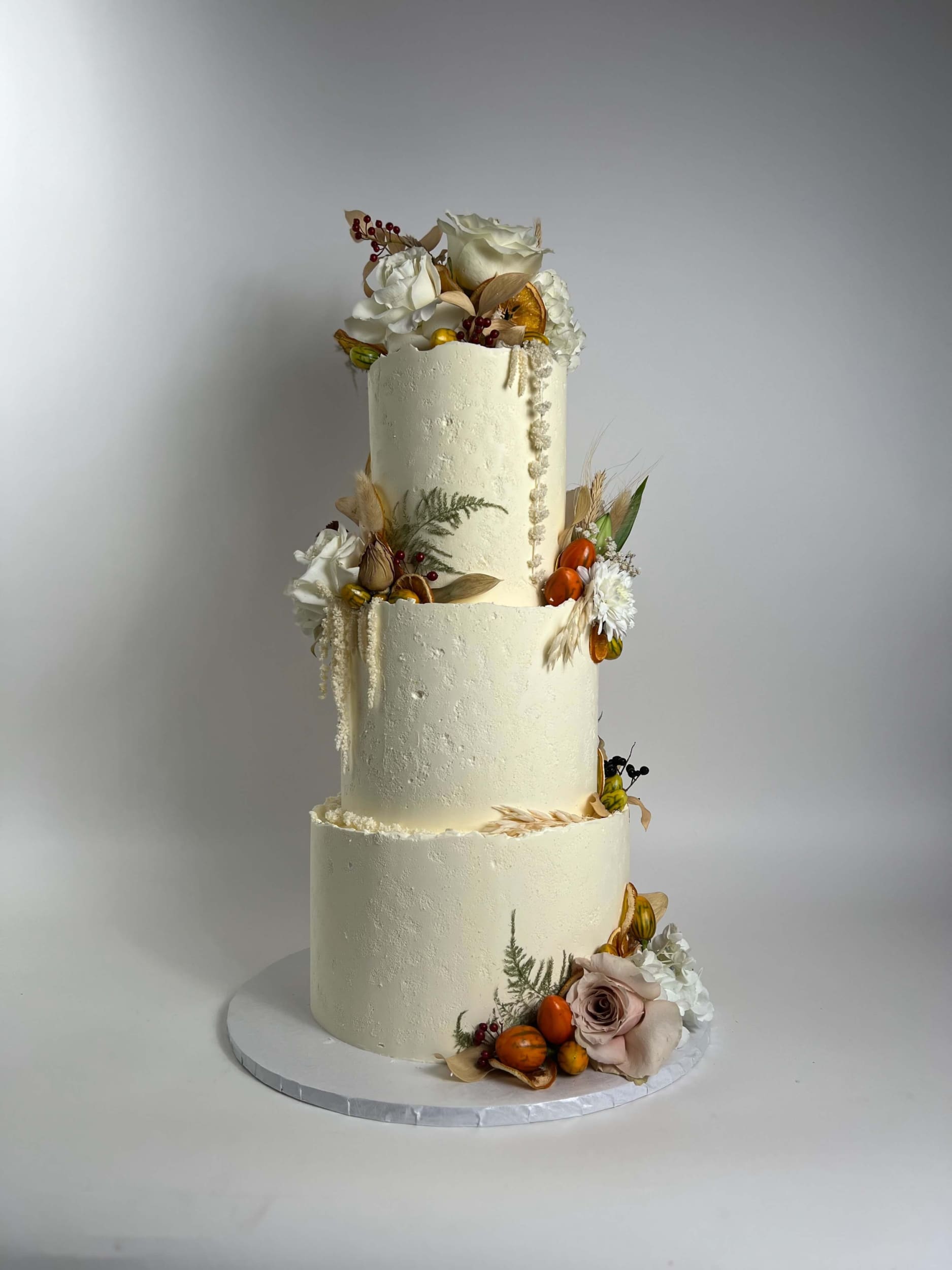 Seasonal fruits & fresh flowers on deckled edge buttercream - wedding cake