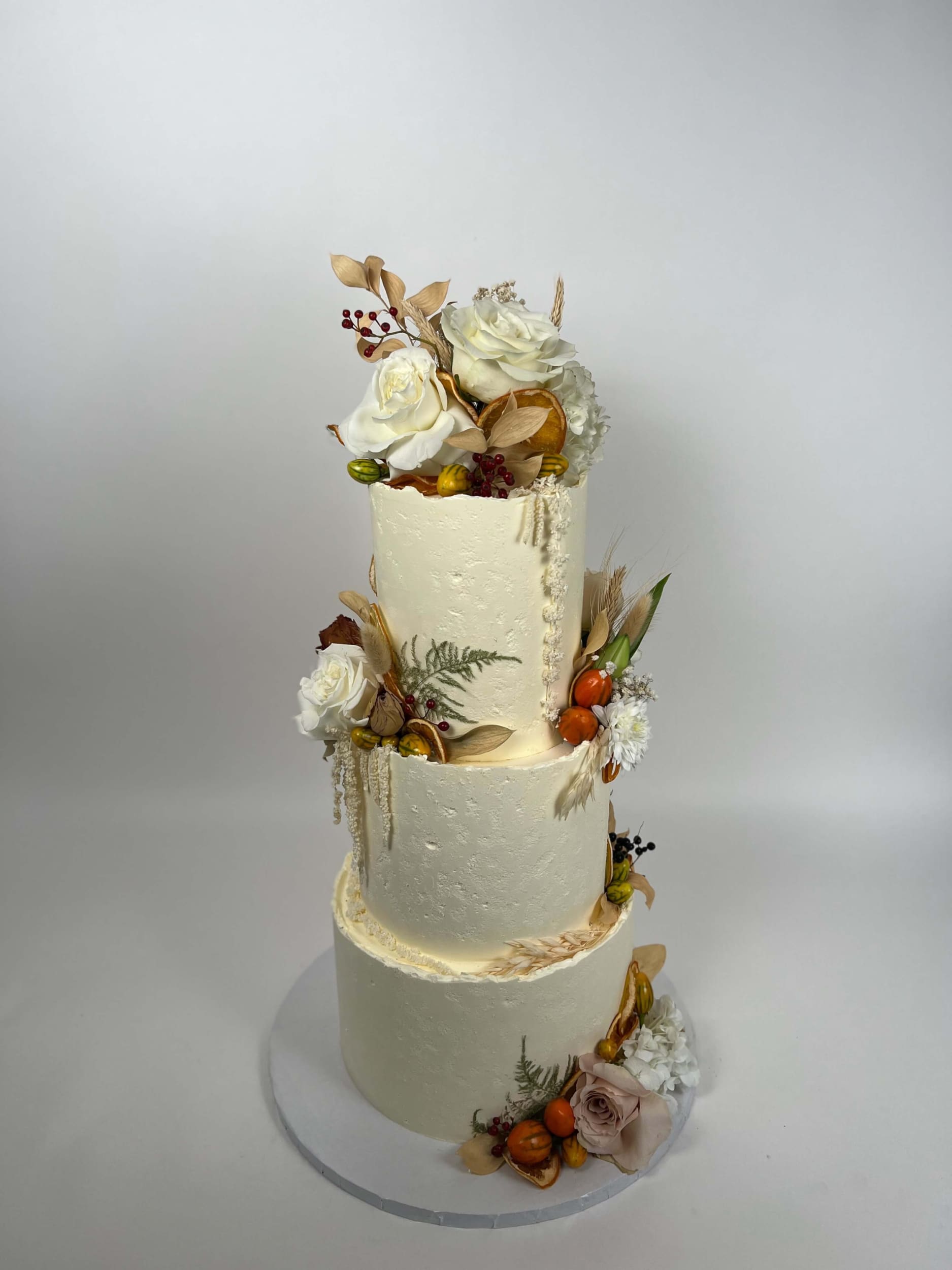 Seasonal fruits & fresh flowers on deckled edge buttercream - wedding cake