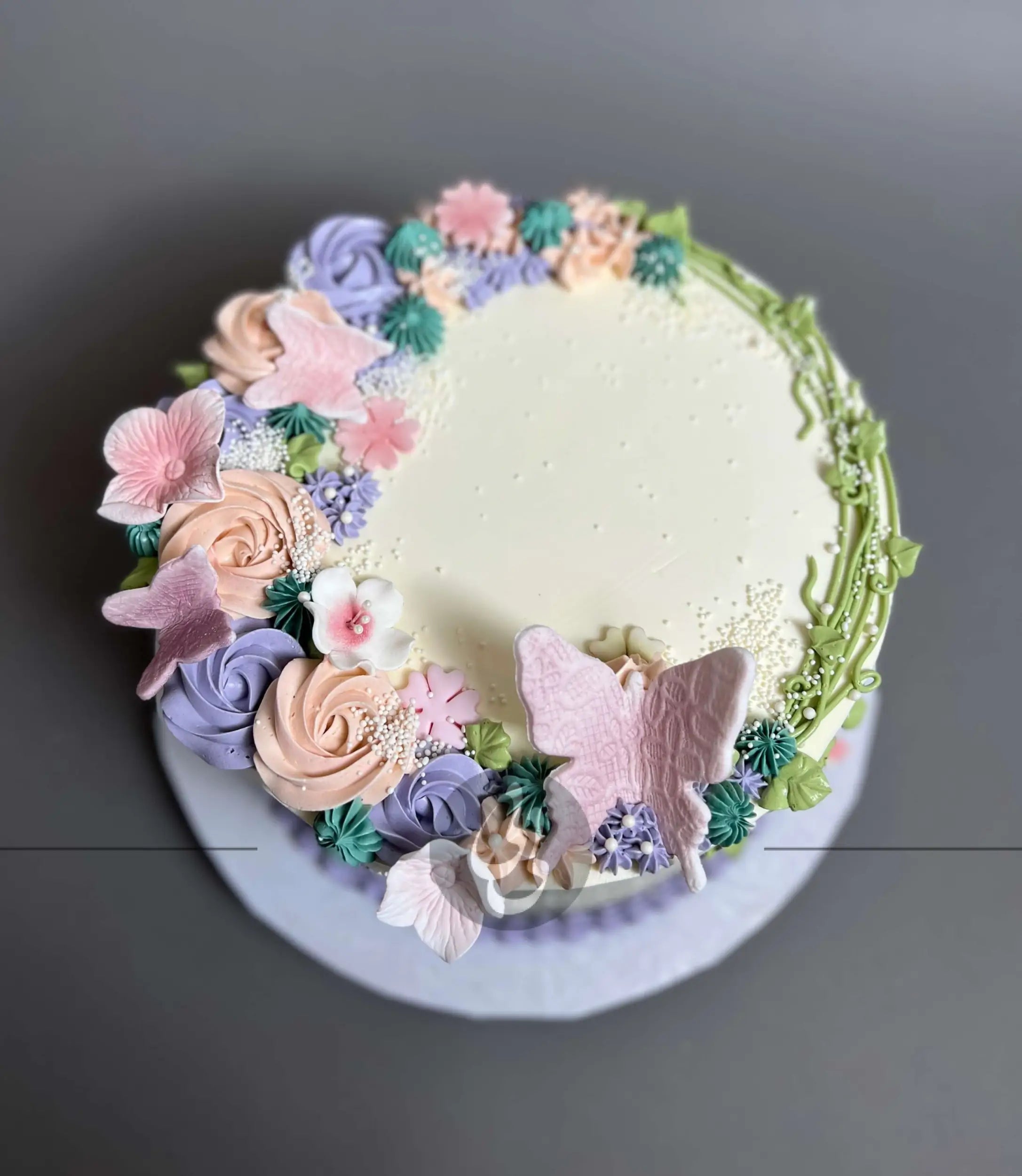 Vines and rosette butterfly on buttercream - custom cake
