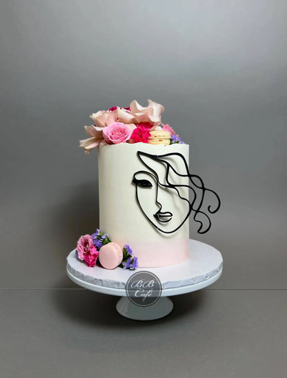 Abstract face and florals on buttercream - custom cake