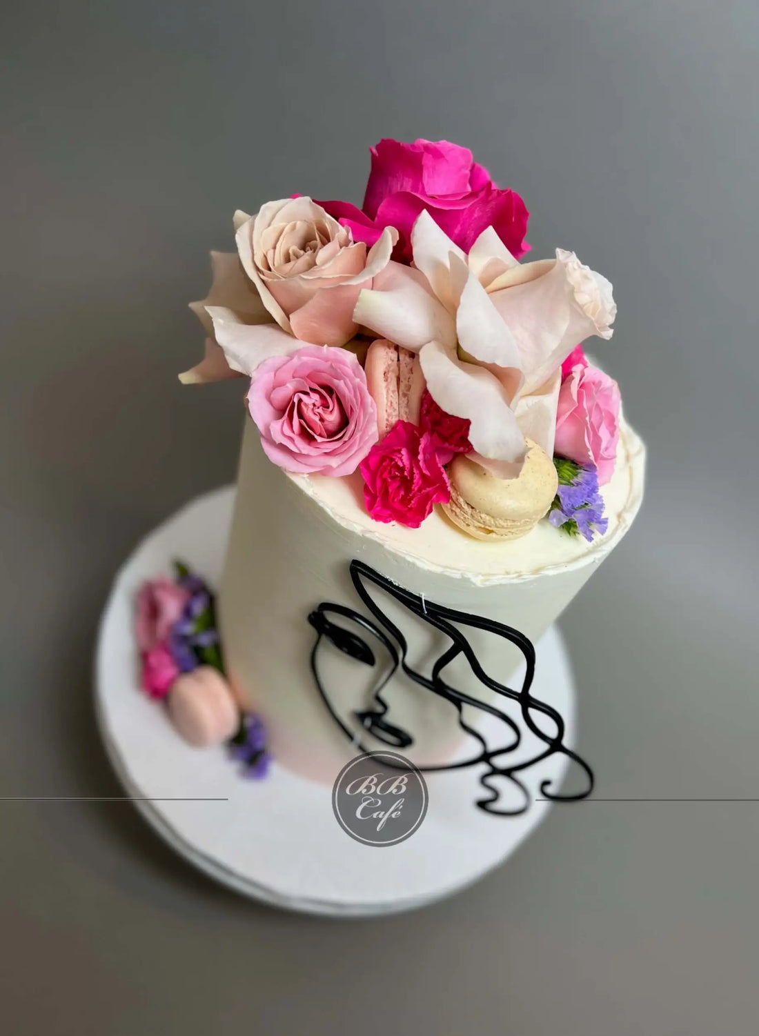 Abstract face and florals on buttercream - custom cake