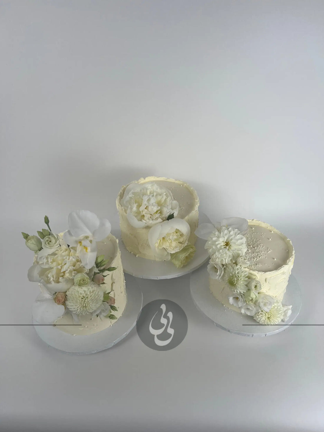 Cascading fresh blooms on buttercream - wedding cake