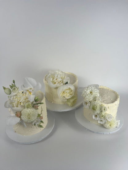 Cascading fresh blooms on buttercream - wedding cake