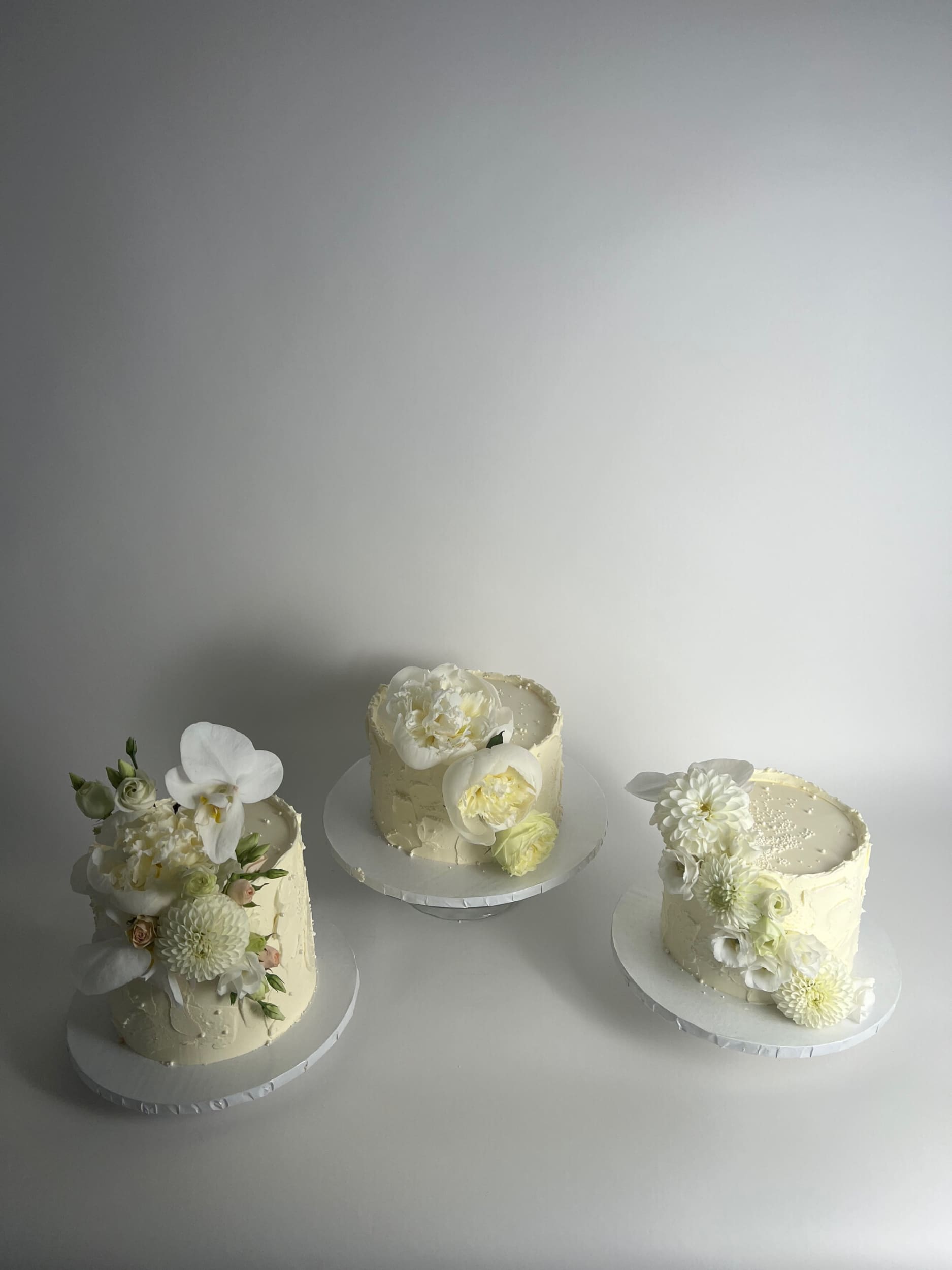 Cascading fresh flowers on buttercream - wedding cake