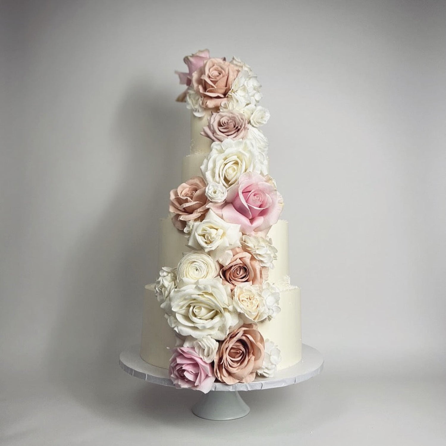 Cascading fresh flowers on buttercream - wedding cake
