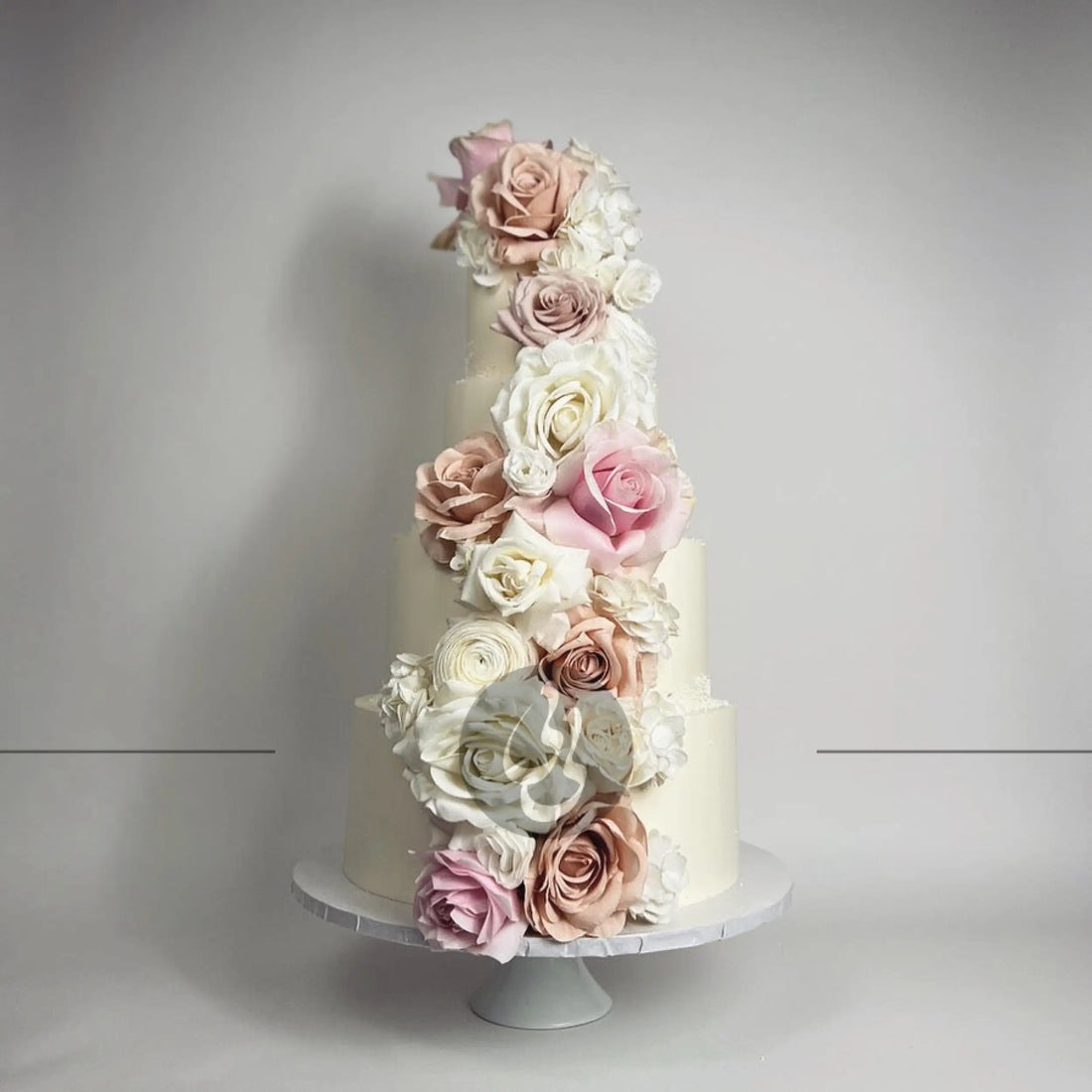 Cascading fresh flowers on buttercream - wedding cake