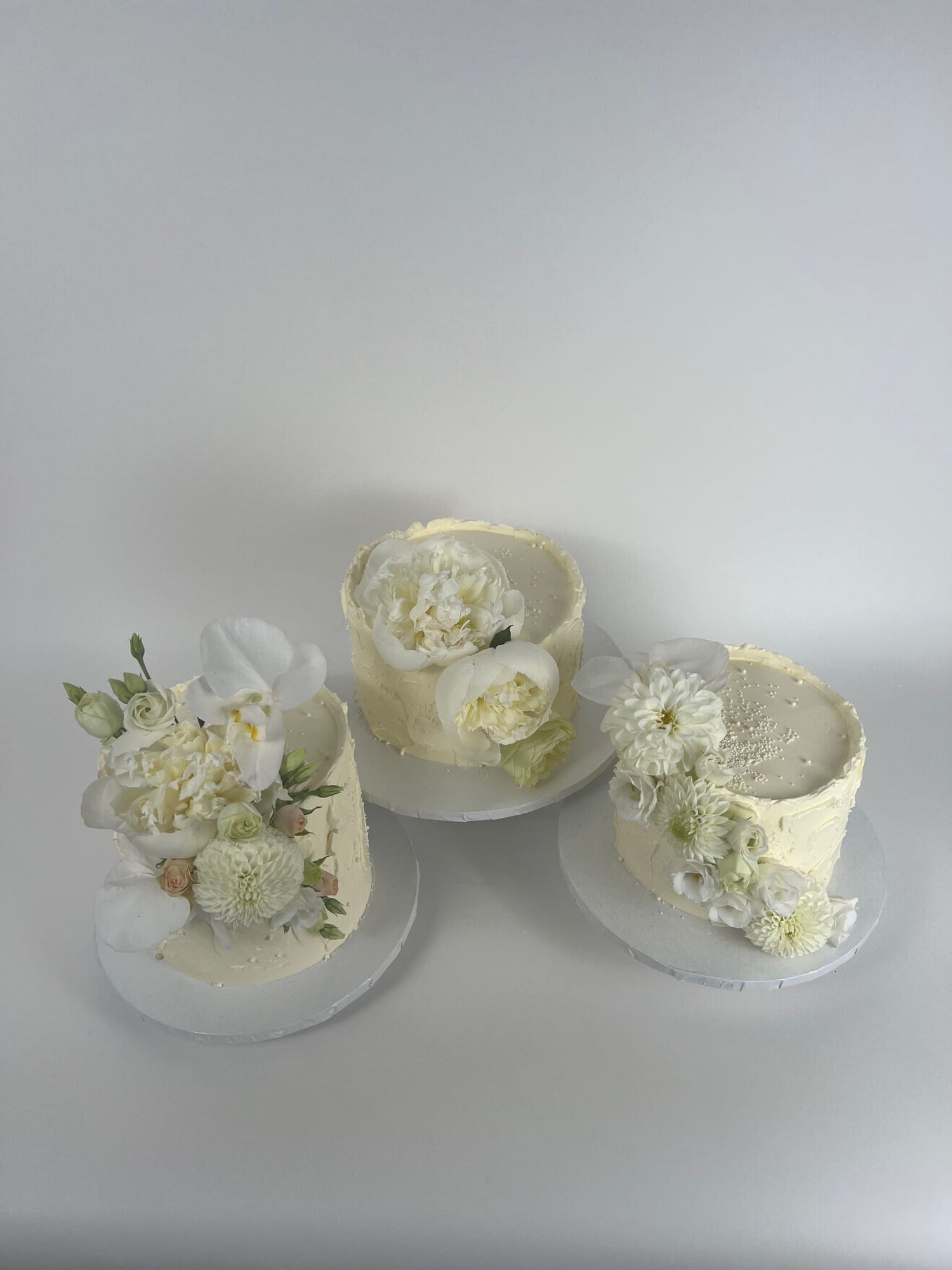 Cascading fresh flowers on buttercream - wedding cake