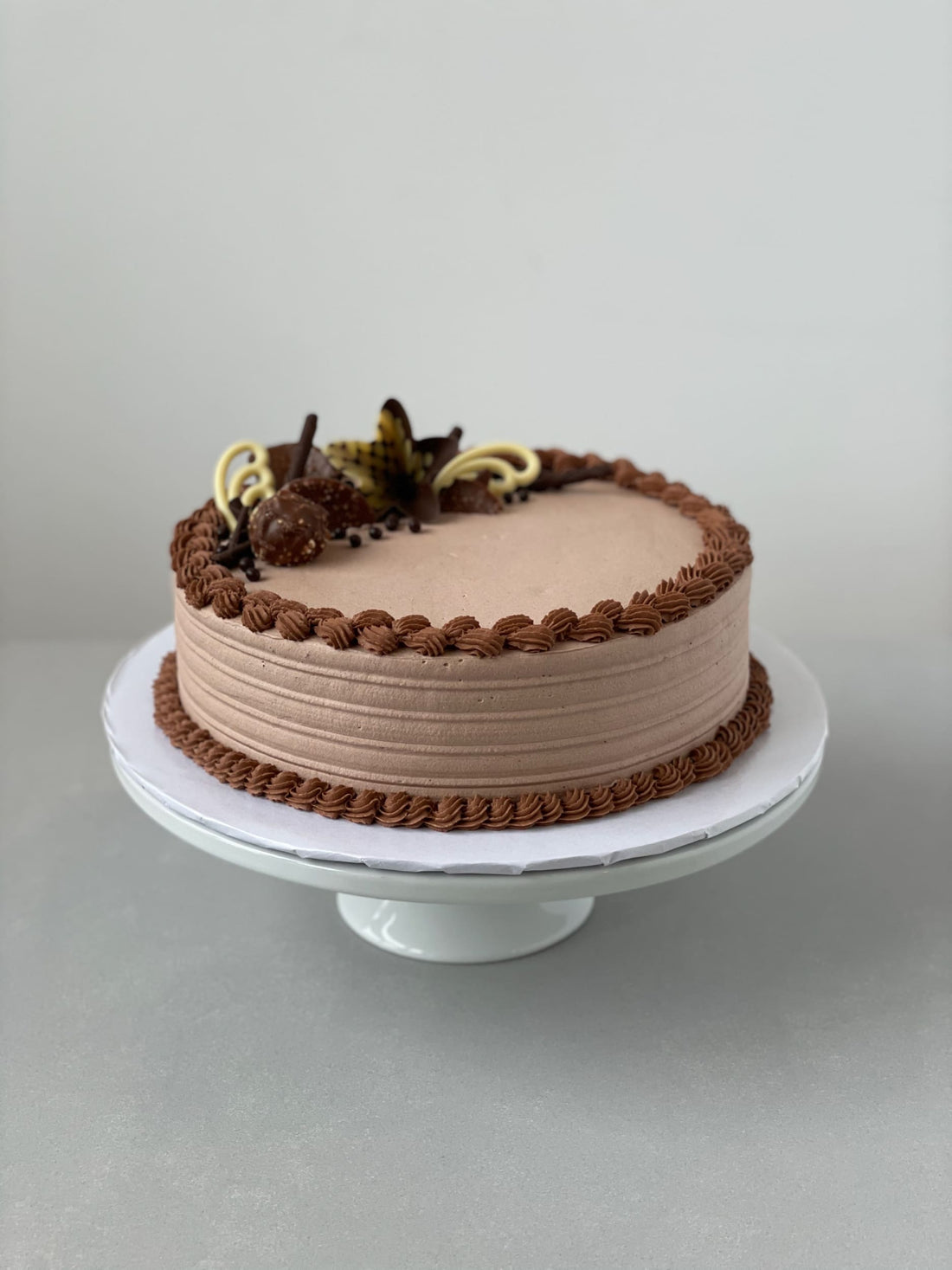 Chocolate decorations on whipped cream - custom cake