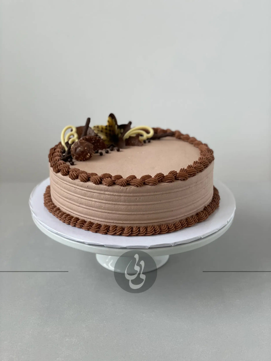 Chocolate decorations on whipped cream - custom cake
