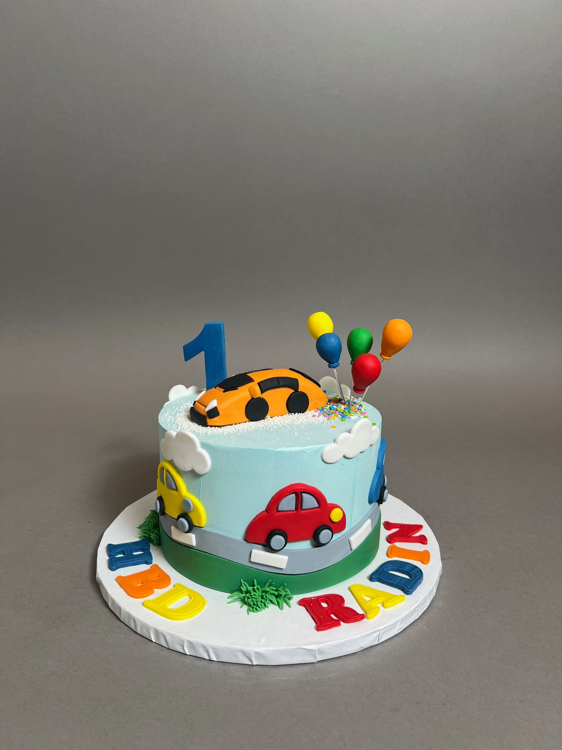 Colourful cars on buttercream - custom cake
