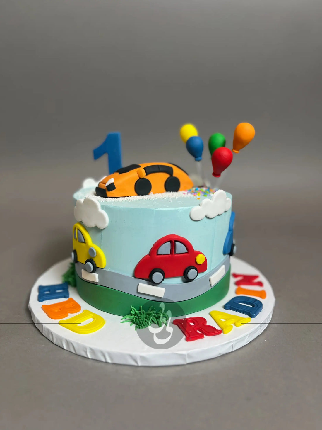 Colourful cars on buttercream - custom cake