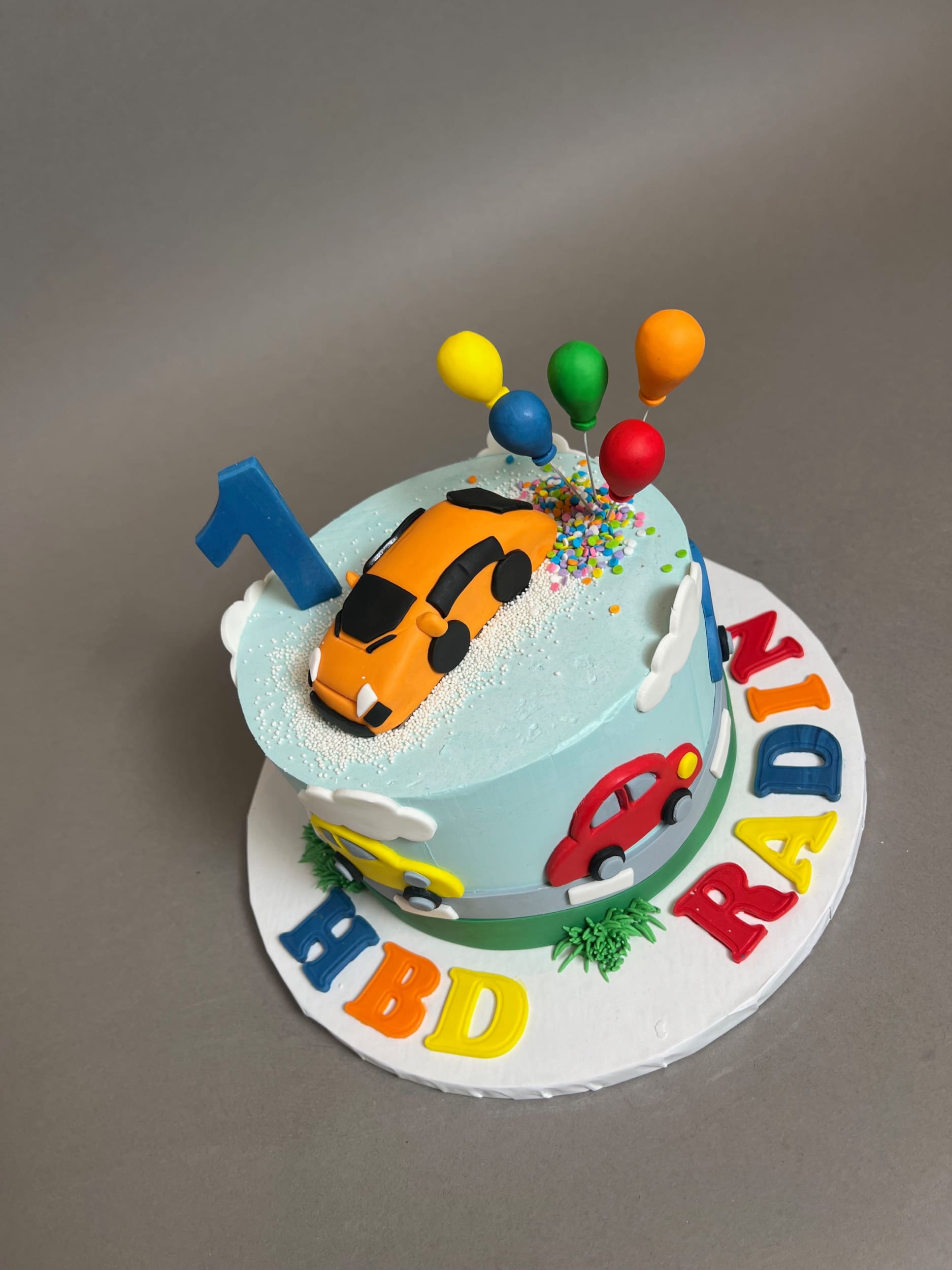 Colourful cars on buttercream - custom cake
