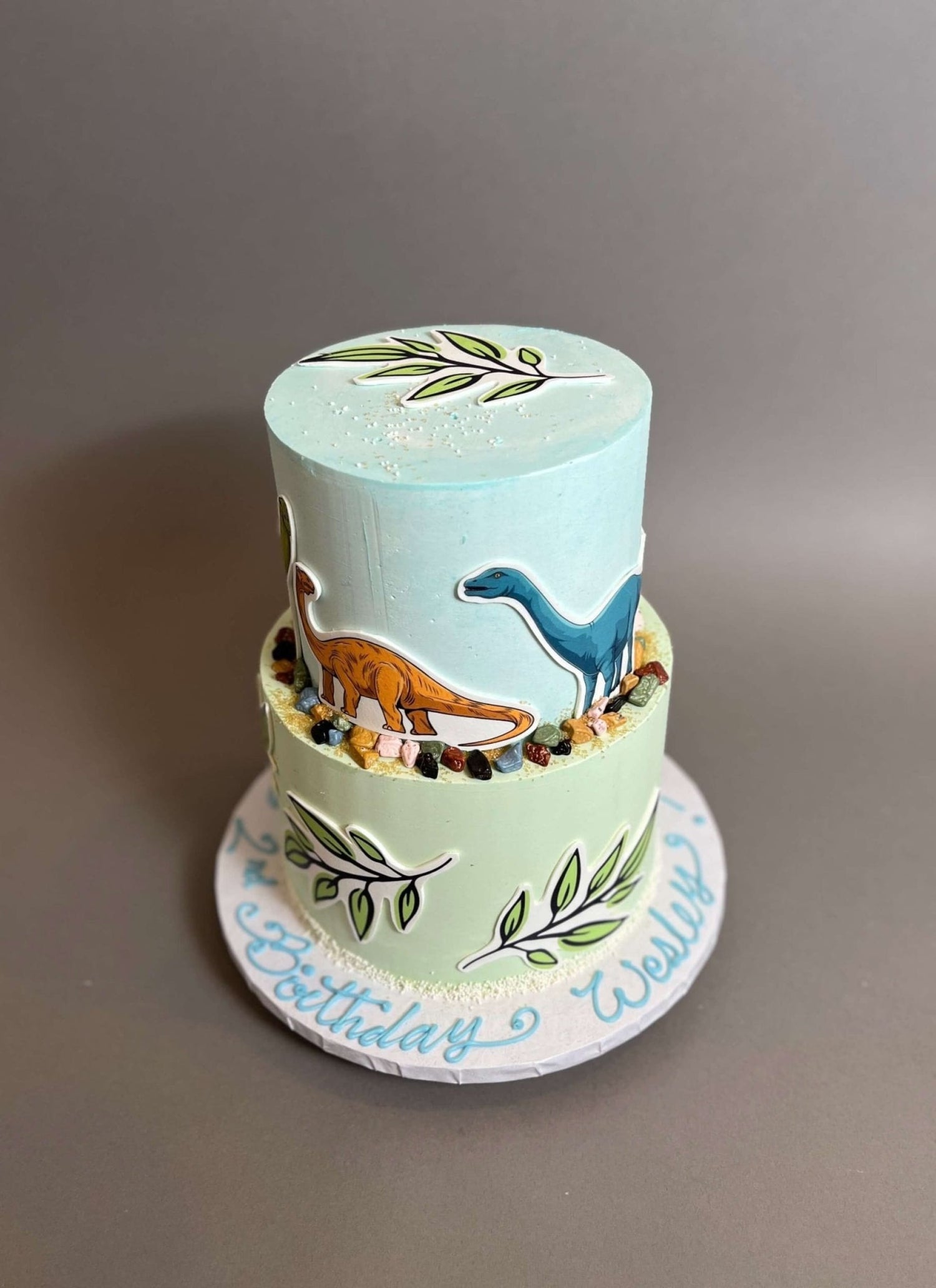 Dinosaur print &amp; leaves on buttercream - custom cake