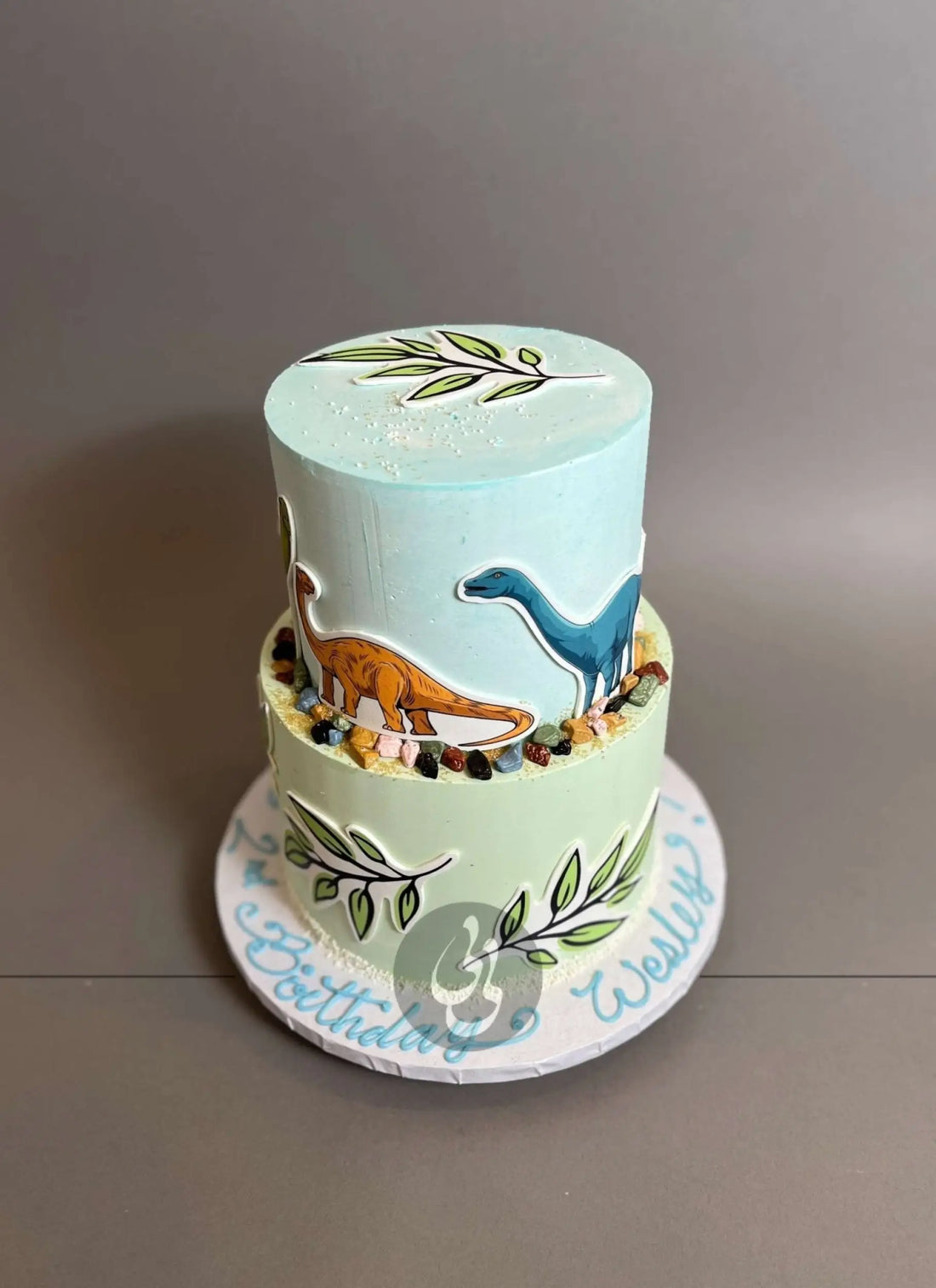 Dinosaur print &amp; leaves on buttercream - custom cake