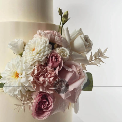 Fresh flowers on smooth buttercream - wedding cake