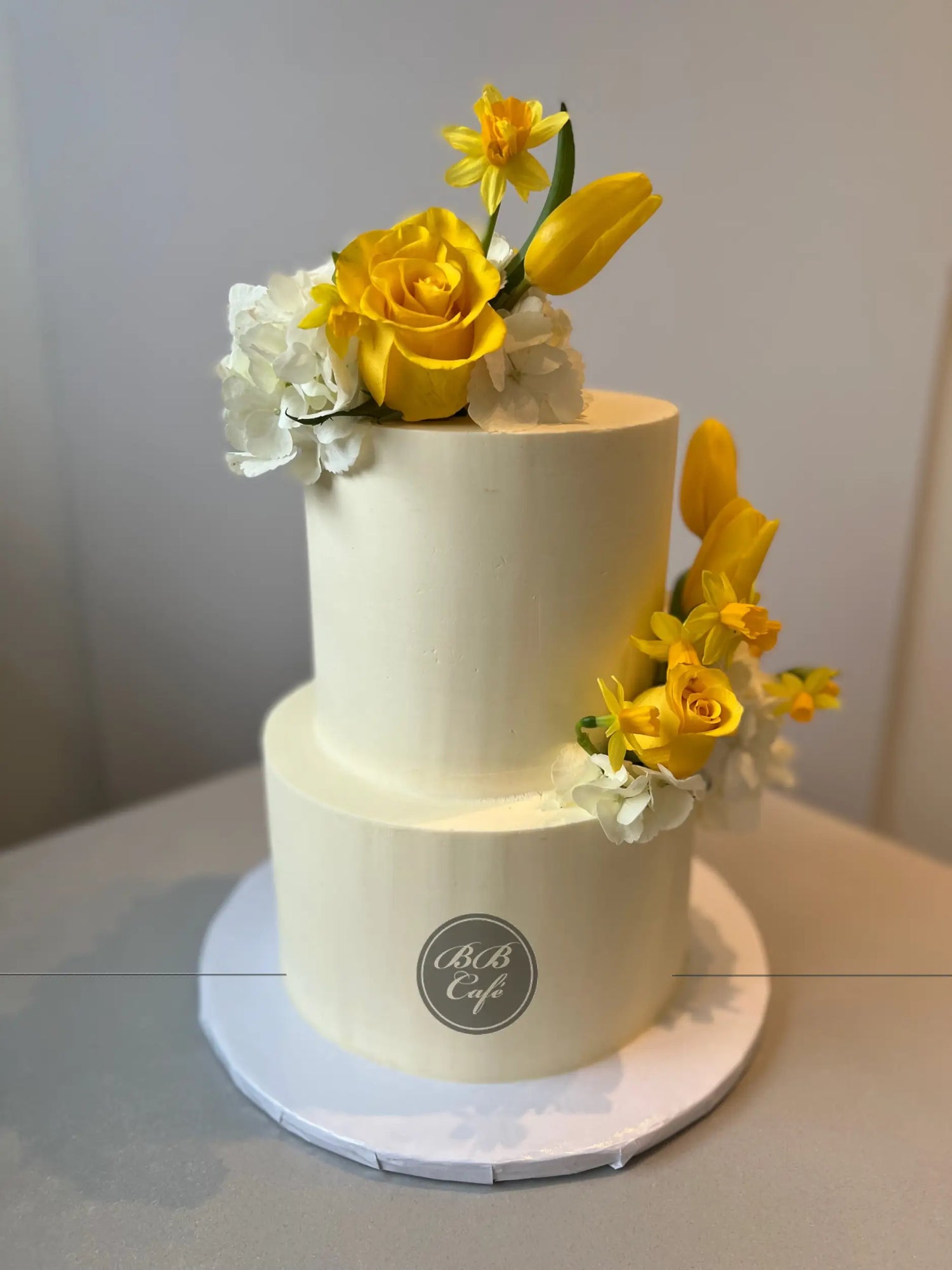 Fresh blooms on buttercream - wedding cake