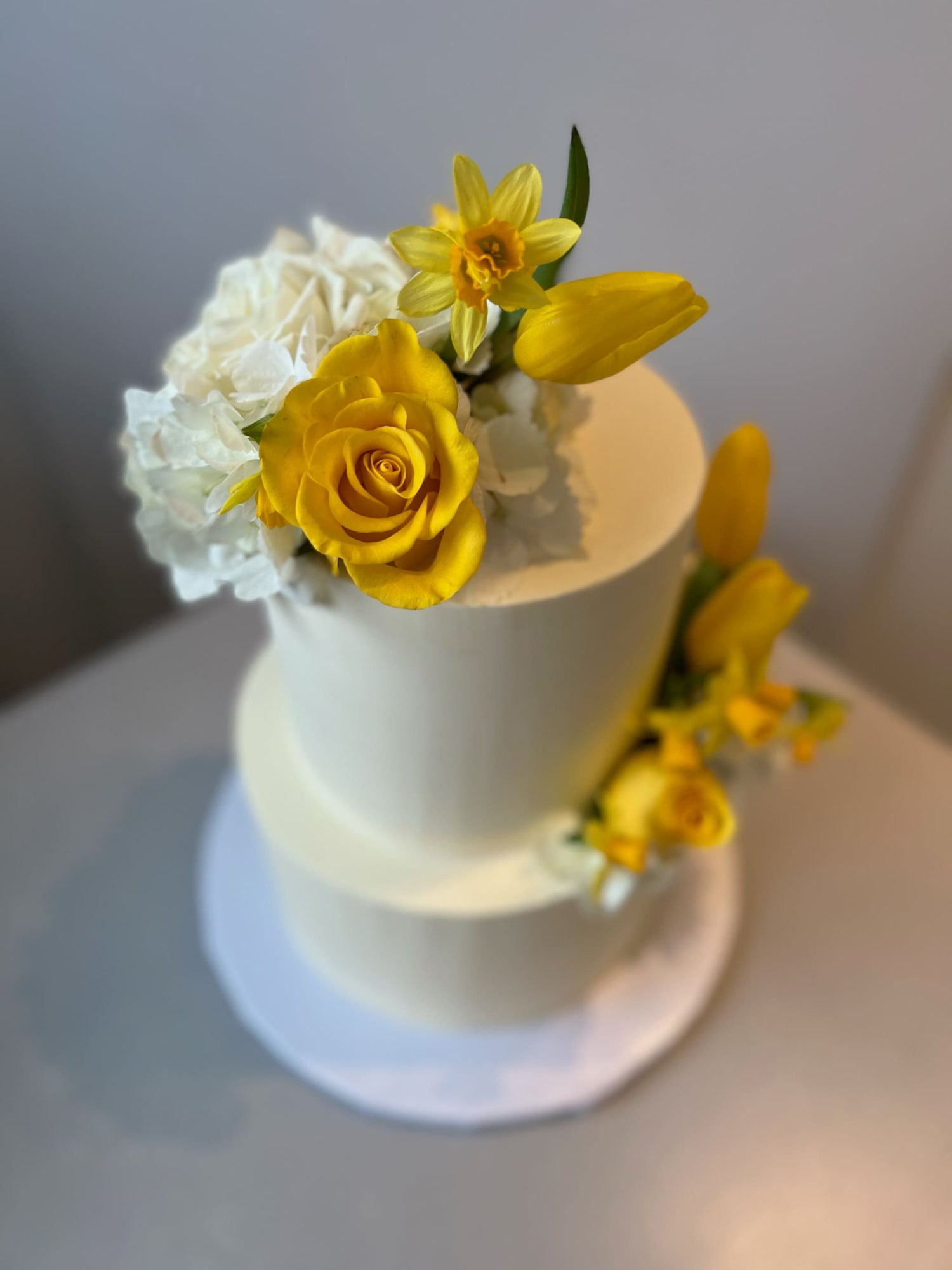 Fresh blooms on buttercream - wedding cake